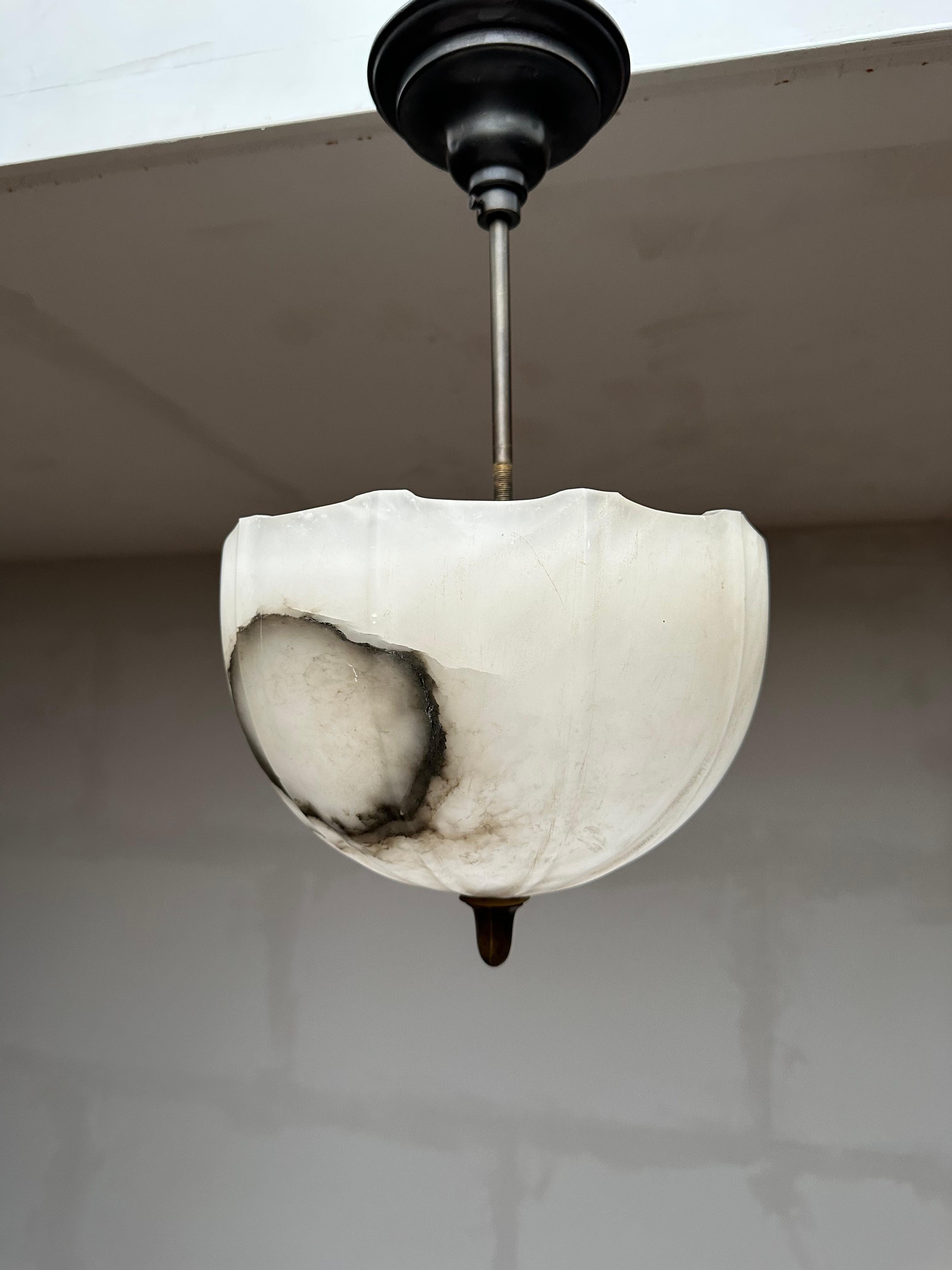 Unique and small size, two-light, white alabaster ceiling lamp of superb quality and condition.

This light fixture from the heydays of the European Art Deco era will light up both your days and evenings. Its timeless shade is all hand carved out of