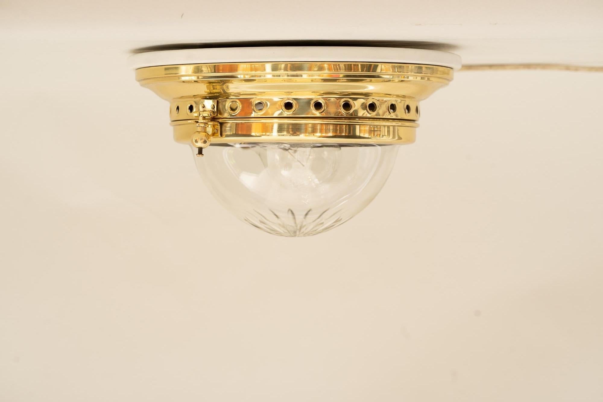 Small art deco ceiling lamp with original cut glass shade around 1920s.
White painted wood plate on top.
Polished and stove enameled.
Bulb is e27.