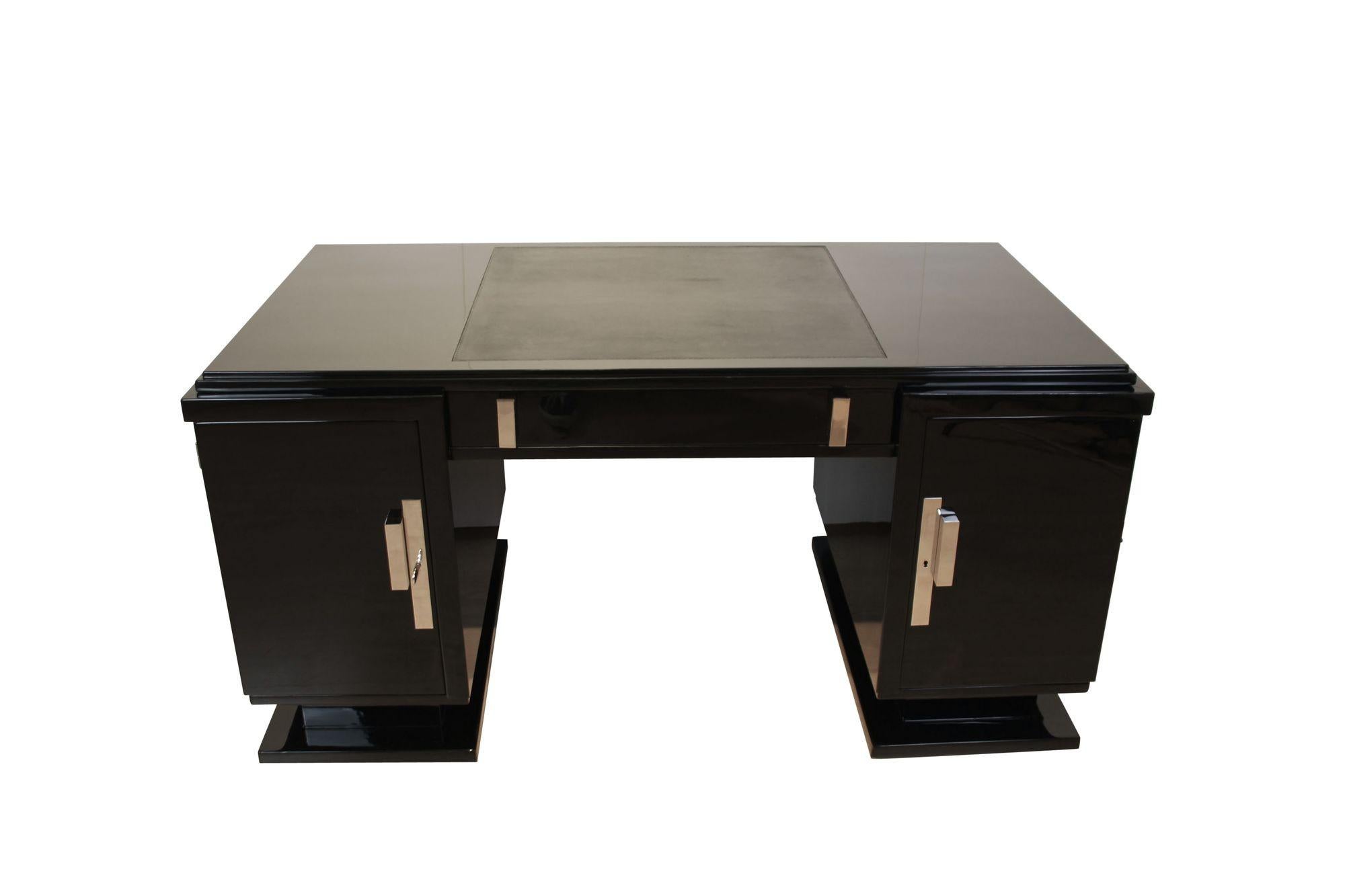 Elegant straightlined Art Deco Desk from France circa 1930.
Fully restored condition with black high-gloss piano lacquer finish.
Original, newly nickel-plated bronze handles. Original embossed leather plate dyed in black. Original lock, working. One