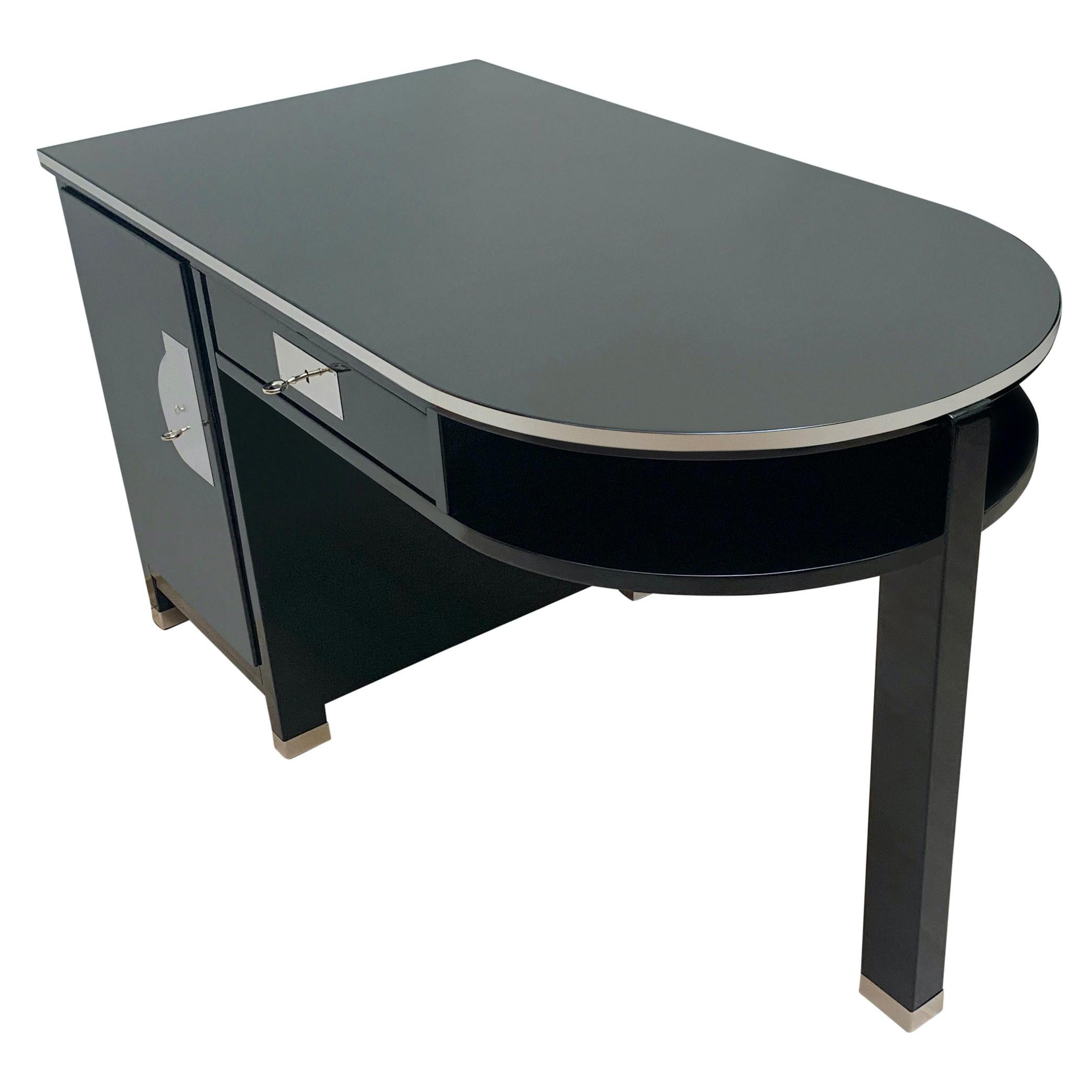 Very elegant, small and functional Art Deco writing desk from France, circa 1930.

Black piano lacquer on hardwood veneered on softwood.
High-gloss polished decorative metal strips around the plate and all five legs.
Nickel-plated handle on the