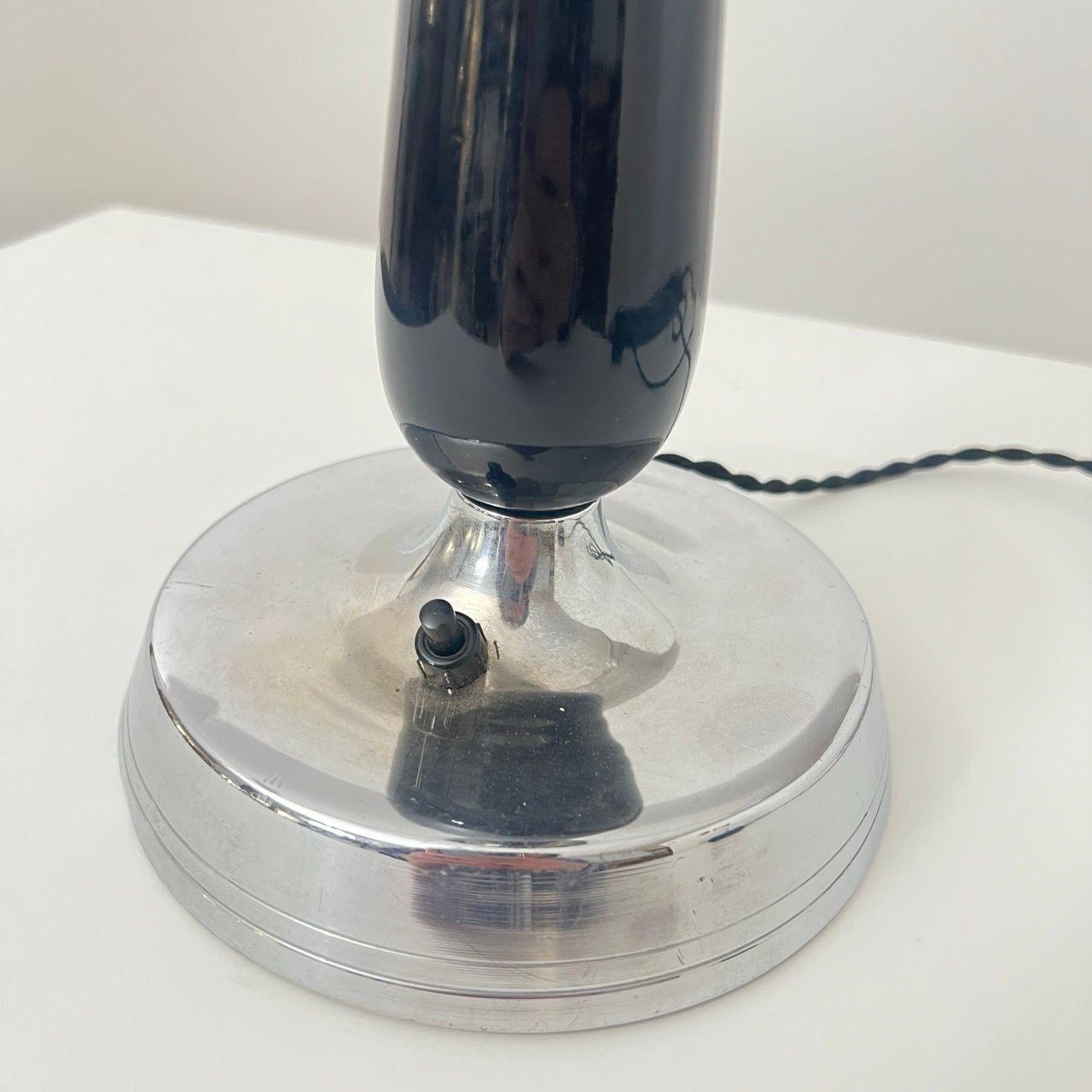 Small Art Deco Table Lamp in Black Lacquer, Chrome and Glass from France circa 1930.
* Wooden column, high-gloss black lacquered
* Chrome-plated metal parts
* Original glass
* Newly electrified, functional with European plug
Dimensions:
* H 49 cm
*