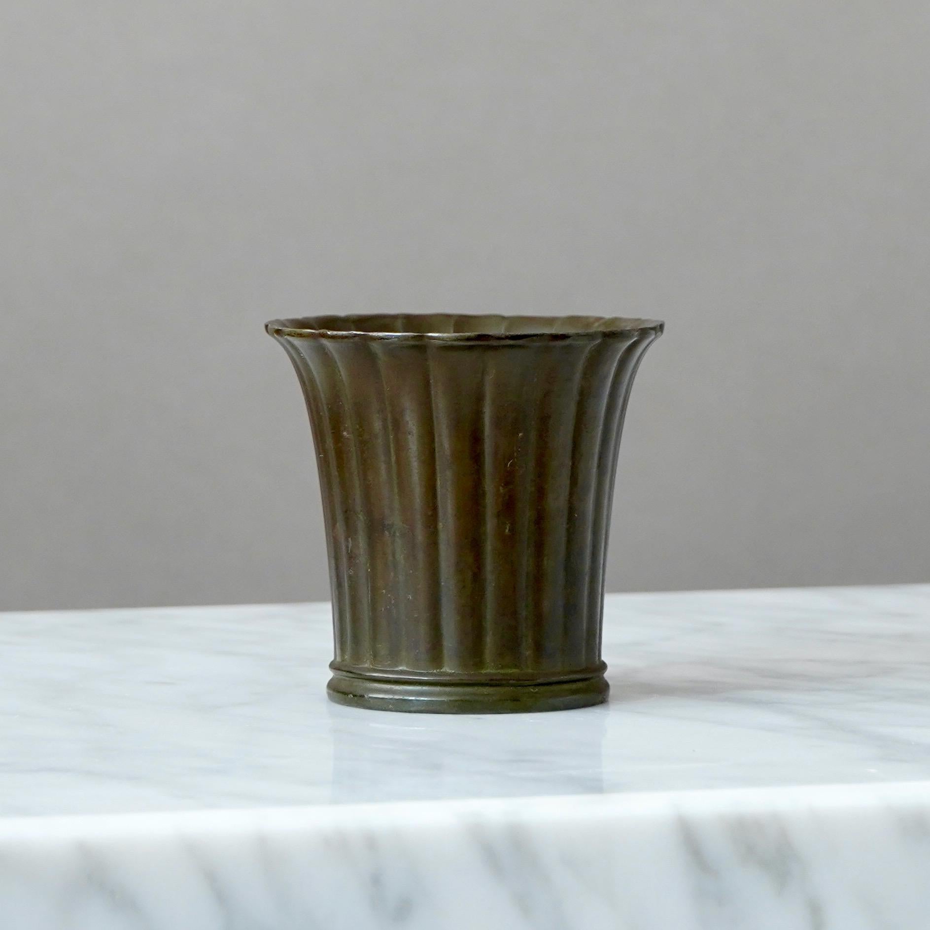 A small but beautiful art deco vase designed by Just Andersen in 1930s and produced by his own company in Denmark. Made from Disko metal (an alloy of different metals invented by Just Andersen).

Good condition. But with some scuffs and