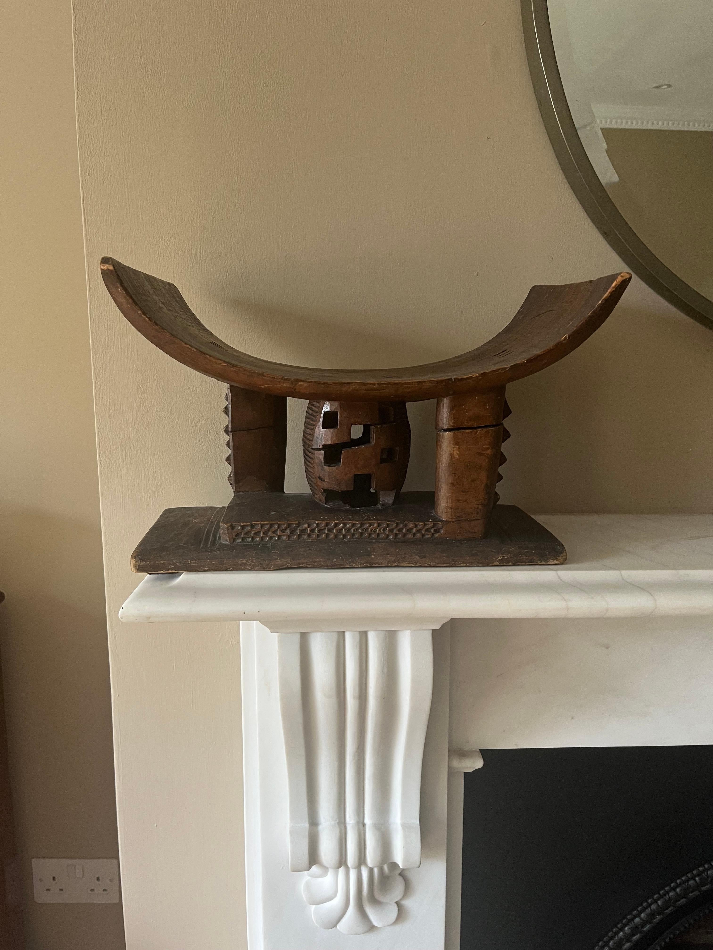 A wonderful small early 20th century Ashanti tribal stool, headrest. Carved from a single piece of wood. Well worn and genuine tribal stool or headrest. 
