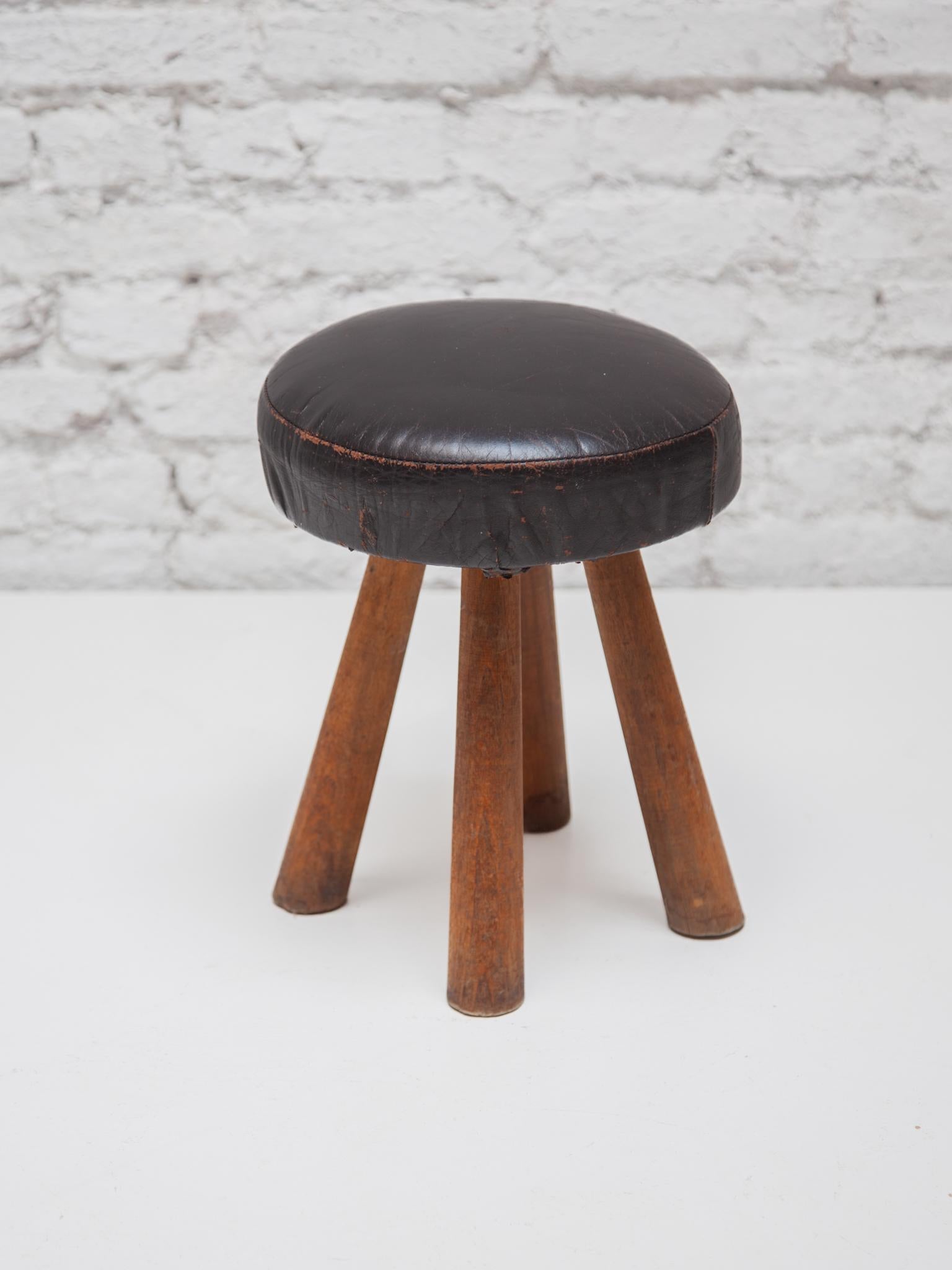 Original small stool with leather seat and four legs, very stable to sit on, also for adults,
to place in front of your fireplace in your living room near the sofa or room for the children.