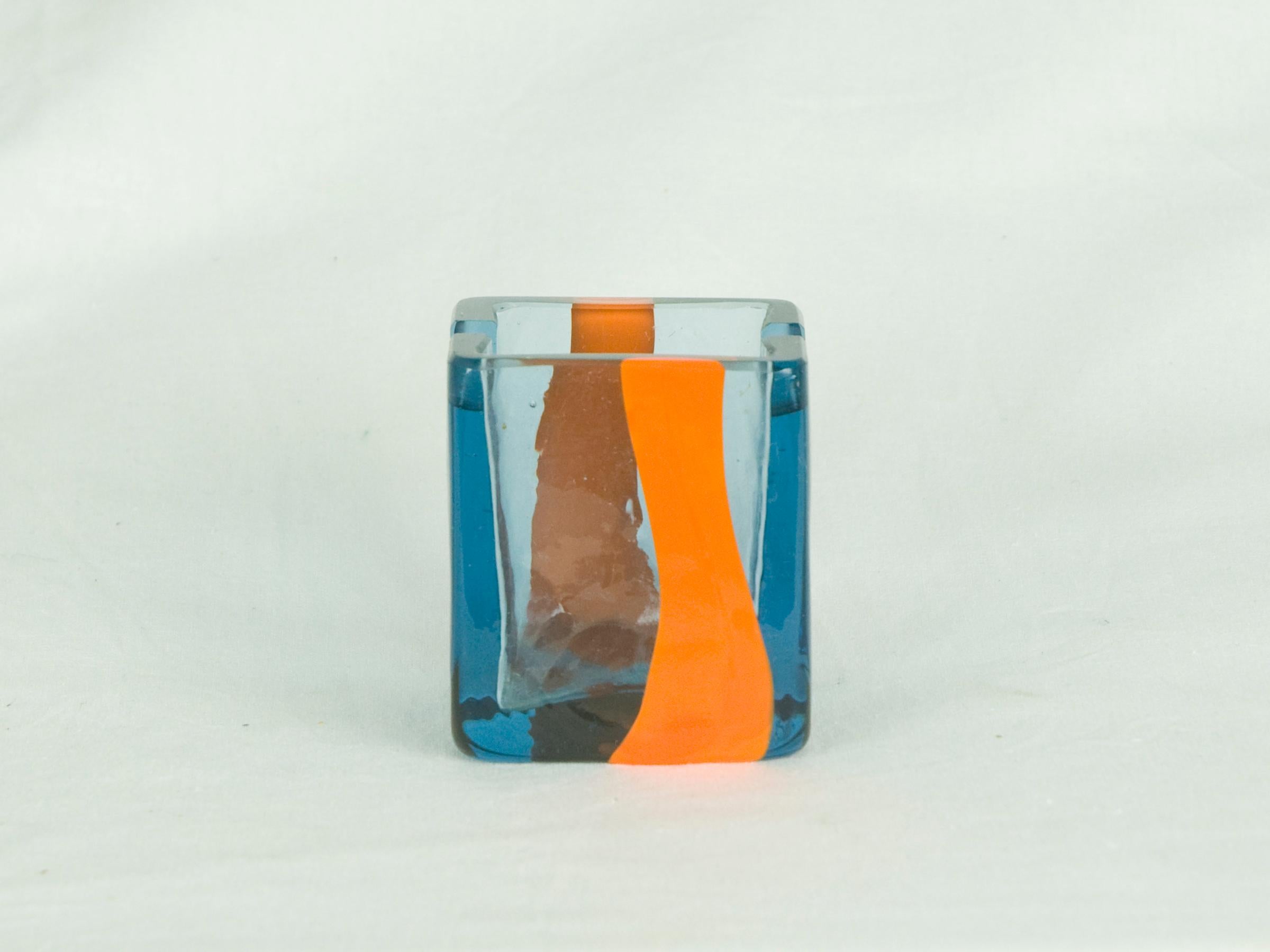 This small ashtray was designed by Pierre Cardin for Venini in the 1960s. It is executed in electric blue with an orange stripe. Engraved signature 