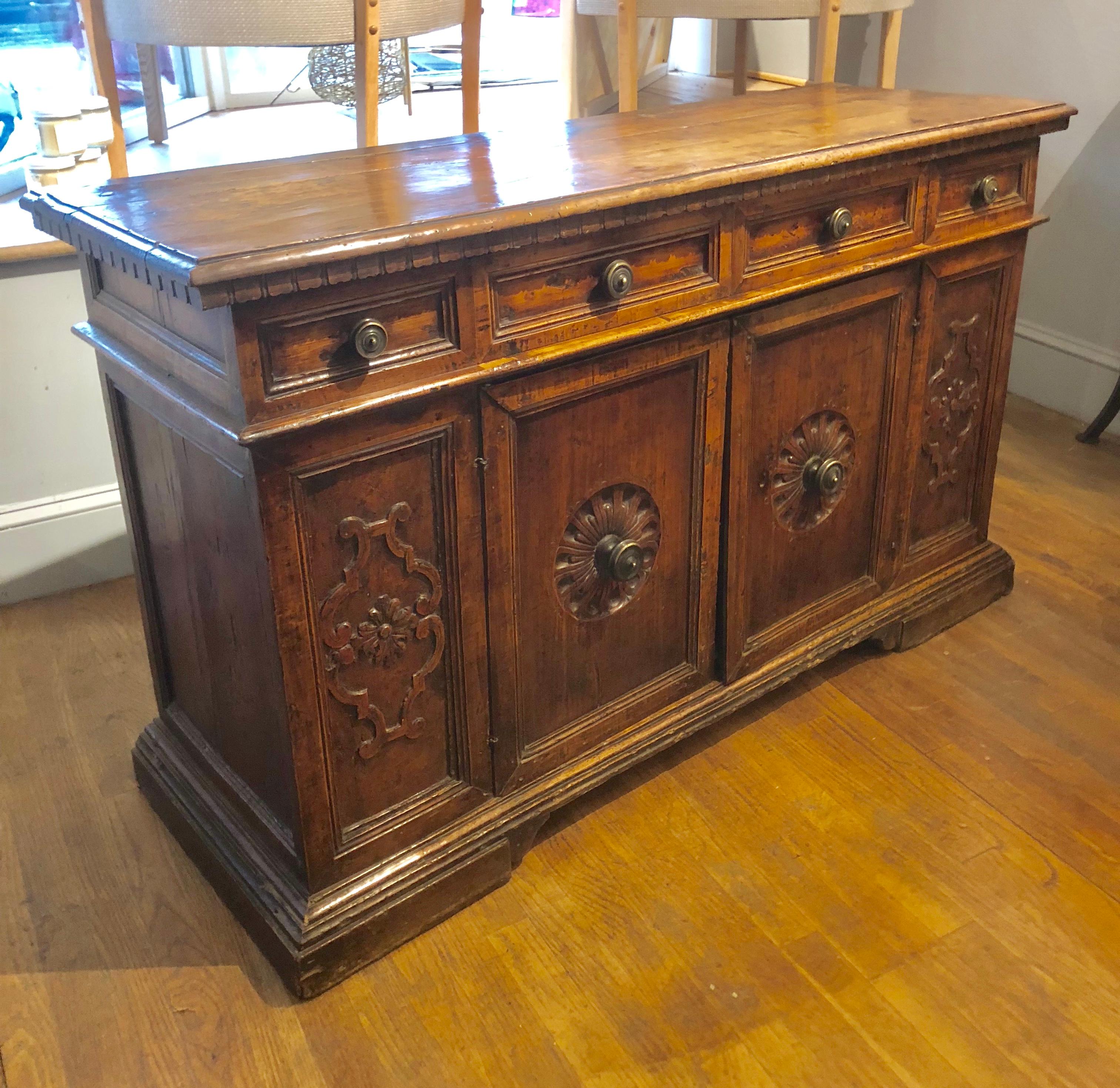 Small Baroque 17th century Italian credenza. Applewood top, the carcass made from a mixture of Circassian walnut and applewood with carved decoration and the original bronze handles, wonderful rich color and lustrous patination. Made in Tuscany,