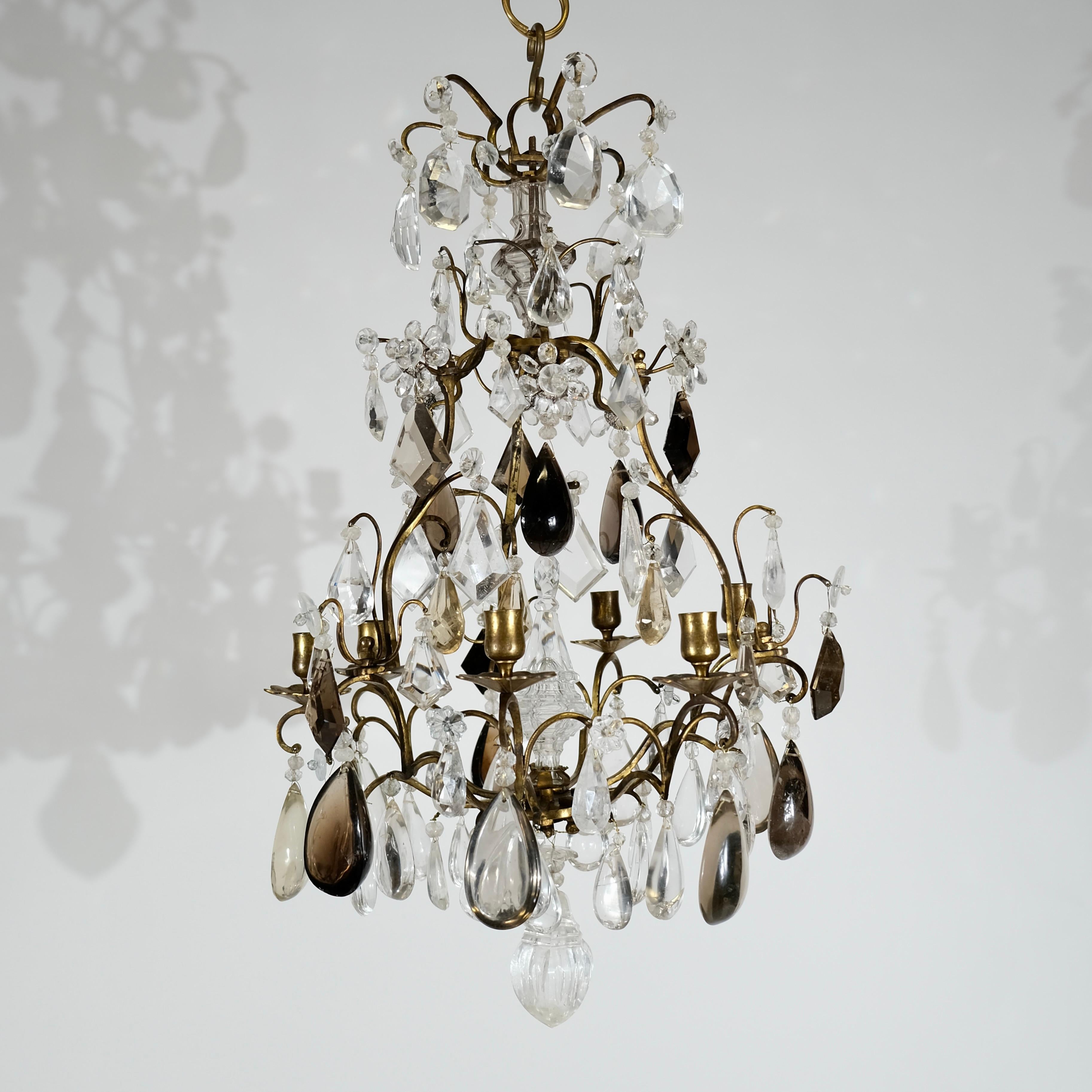 Baroque-style chandelier, adorned with breathtaking rock crystals and smoked topazes. This opulent masterpiece seamlessly blends the lavish aesthetics of the Baroque era with the sparkling allure of genuine rock crystals.
The chandelier is