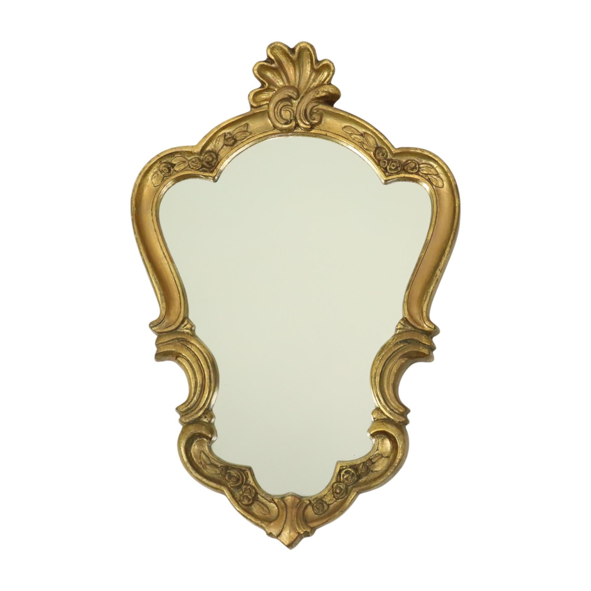 Beautiful small gilded crested mirror with console, entirely in the classic baroque style, circa mid 20th century, France.

Decorated with acanthus leaves and flowers, the mirror and console are made of gold-colored resin. Both items have weathered