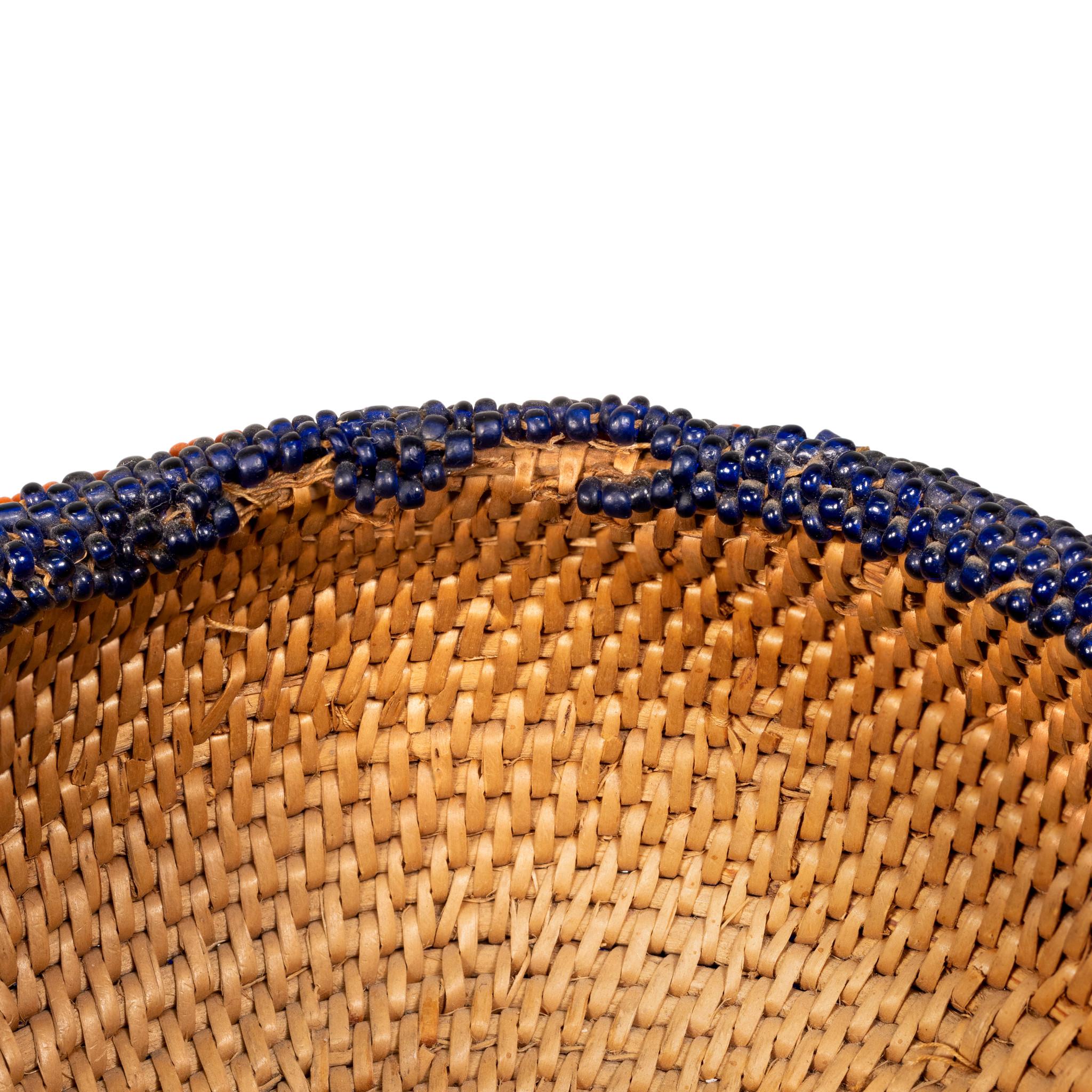 Fully beaded single rod Washoe basket with vibrant colors of blue, yellow and orange inside and out.

Period: circa 1900-1920
Origin: Washoe
Size: 2 1/2