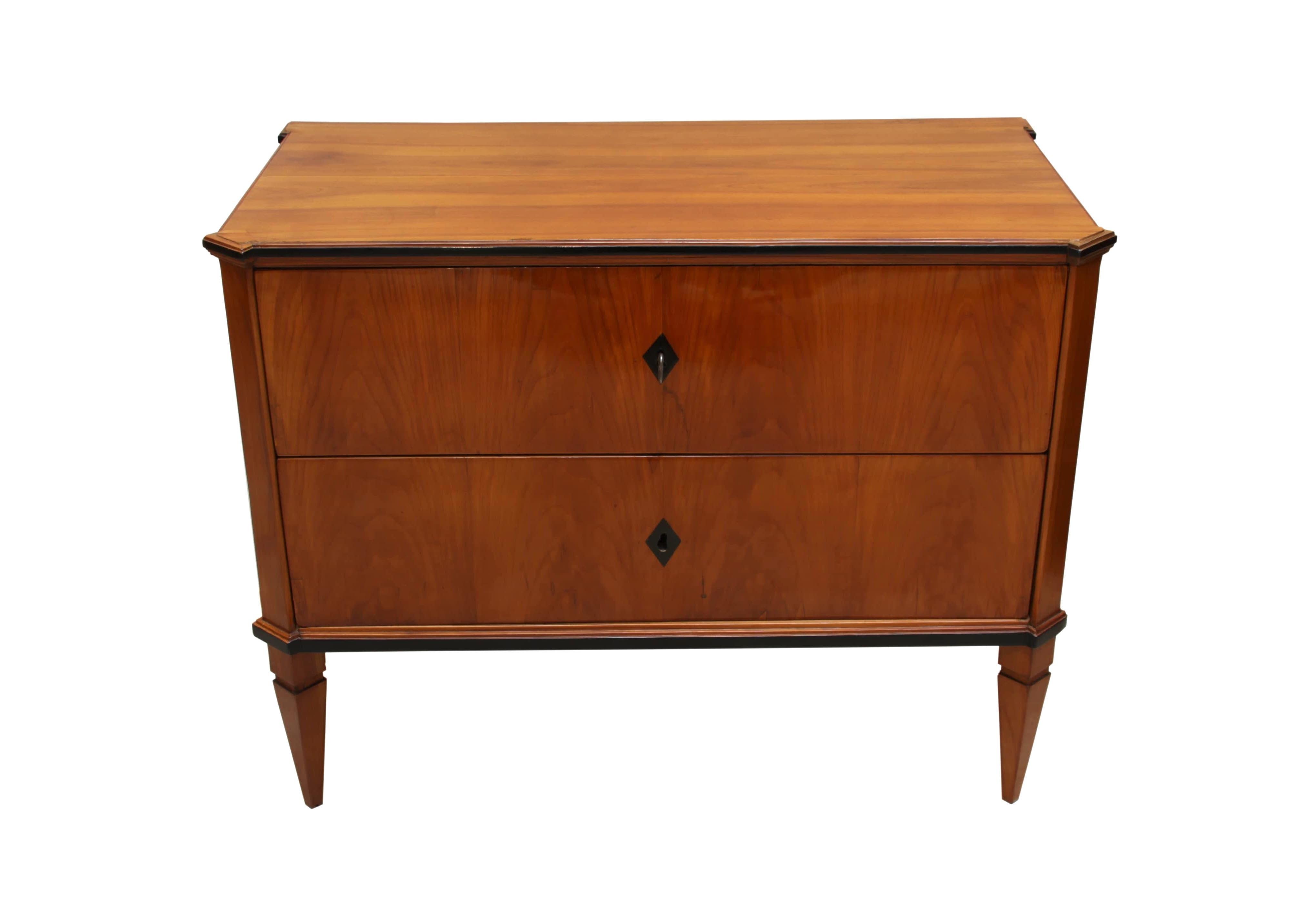 Very beautiful petite, early Biedermeier commode/chest of drawers from South Germany around 1820.

The small size of this two-doored chest of drawers makes it rare. The front, top and sides are veneered with cherry, while the other parts are cheery