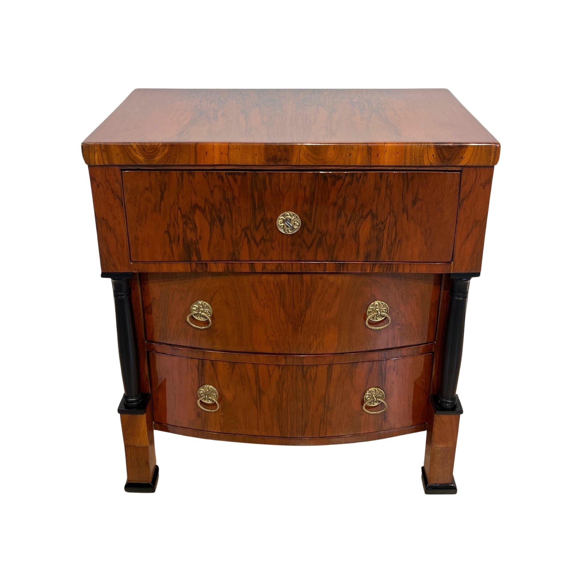 Small Biedermeier Commode in Walnut Veneer with Full Columns and Brass Fittings from Austria circa 1830
Walnut veneered and solid. Two ebonized full columns.
Top drawer straight, bottom two cambered/convex drawers.
Old brass fittings. Restored and