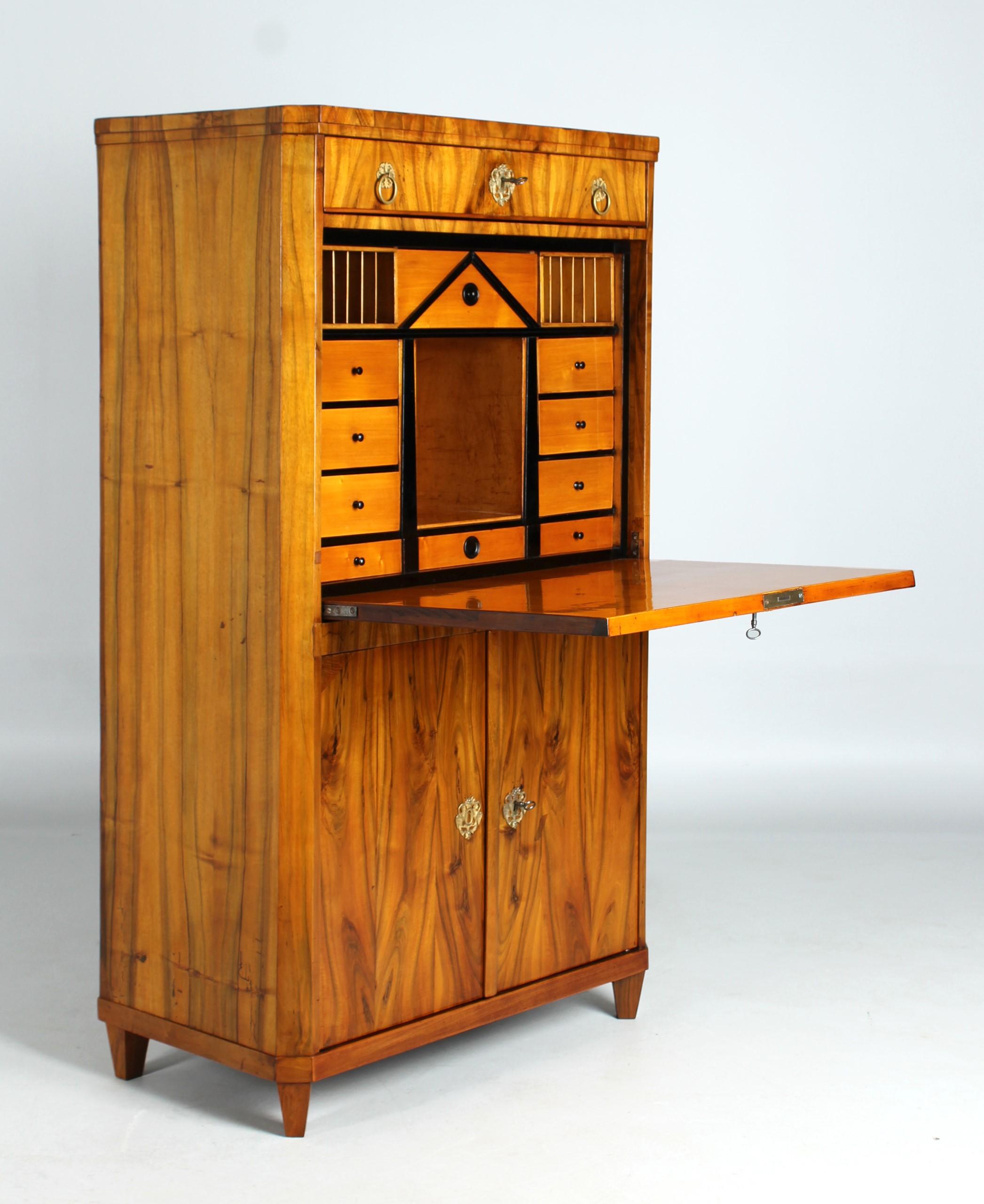Small antique Biedermeier secretary

Austria
Walnut
Biedermeier around 1820

Dimensions: H x W x D: 146 x 84 x 45 cm

Description:
Piece of furniture standing on pointed feet set over the corner with doors at the bottom, the writing flap above and a