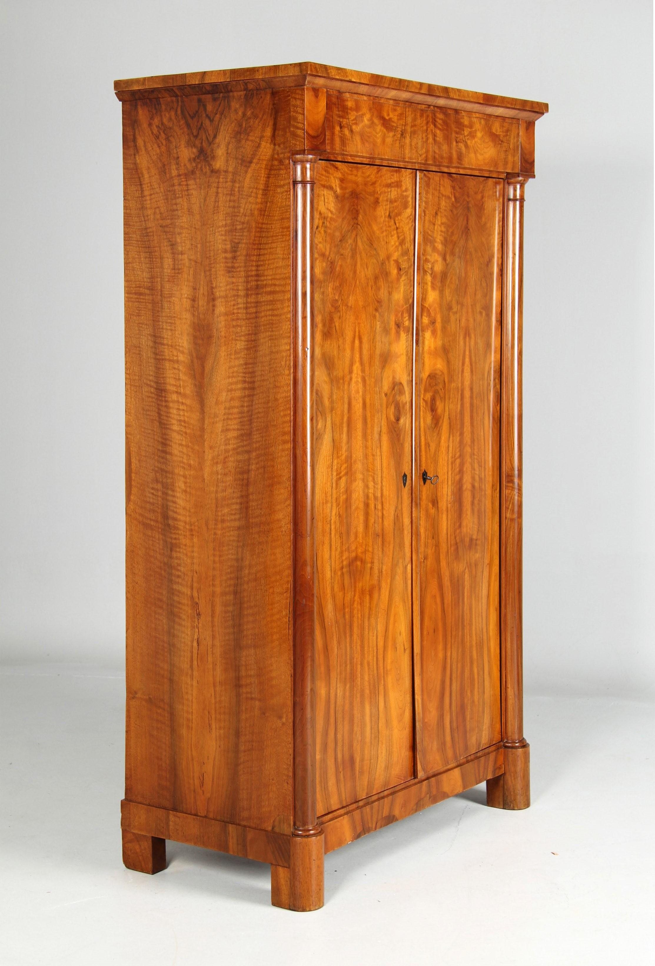 Small antique Biedermeier wardrobe

Southwest Germany
Walnut
Biedermeier circa 1830

Dimensions: H x W x D: 171 x 99 x 52 cm

Description:
Two-door piece of furniture standing on round feet at the front and block feet at the back.

The front of the