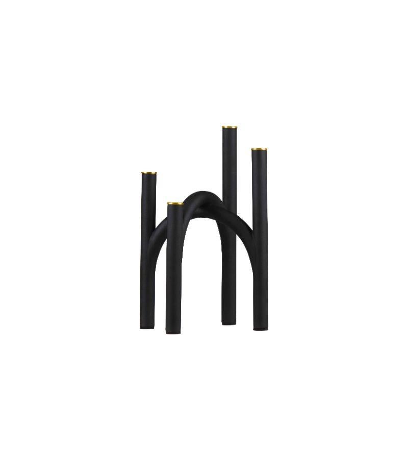 Small black and gold contemporary candleholder
Dimensions: L 22.8 x W 22.8 x H 34 cm 
Materials: Iron. 
Also available in size Large. 

The newest member of the family reinterprets classic traditions of candleholders. With its staggered and