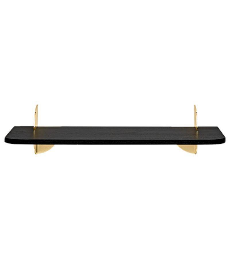 Small black and steel minimalist shelf 
Dimensions: L 50 x W 18 x H 12 cm 
Materials: Steel W. Powder Coating, Brass Plating & Black Ash MDF.
Also available in Walnut and in size large.
Simplicity always seems to make the most sense. The new