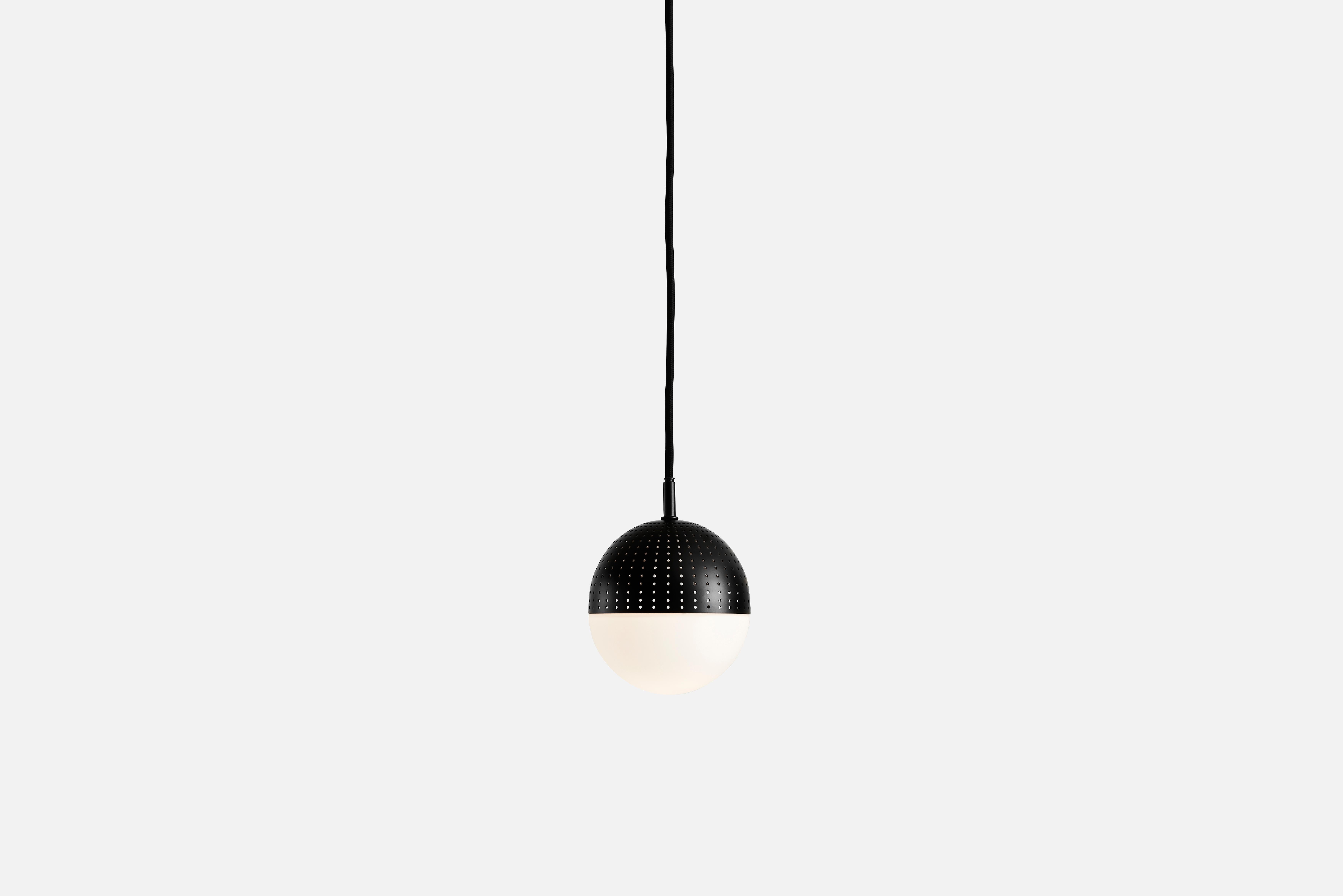 Small black dot pendant lamp by Rikke Frost
Materials: Metal, glass.
Dimensions: D 14 x H 13 cm
Available in black or satin and in 3 sizes: H 13, H 16.6, H 21 cm.

Rikke Frost is a Danish graduate from the School of Architecture Aarhus. Since