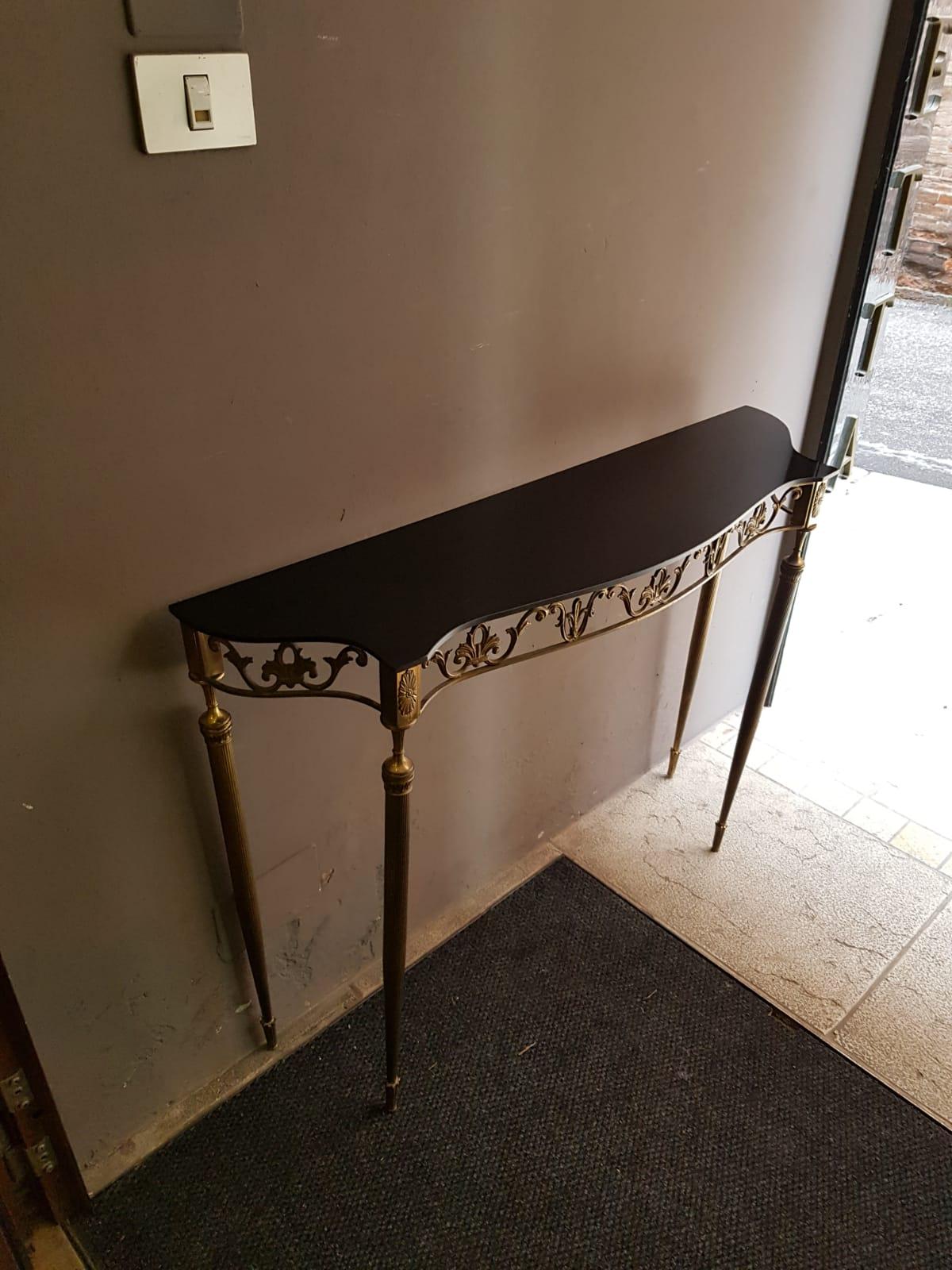 Small black glass golden brass leg structure table console, Italy, 1950s. Thanks to it very small size this console can suits both an entrance or a corridor.

Size: 
W 108 cm - 4233/64in
D 27 cm - 111/32in
H 81 cm - 311/2in.





  