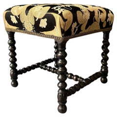Small black square-cushion stool