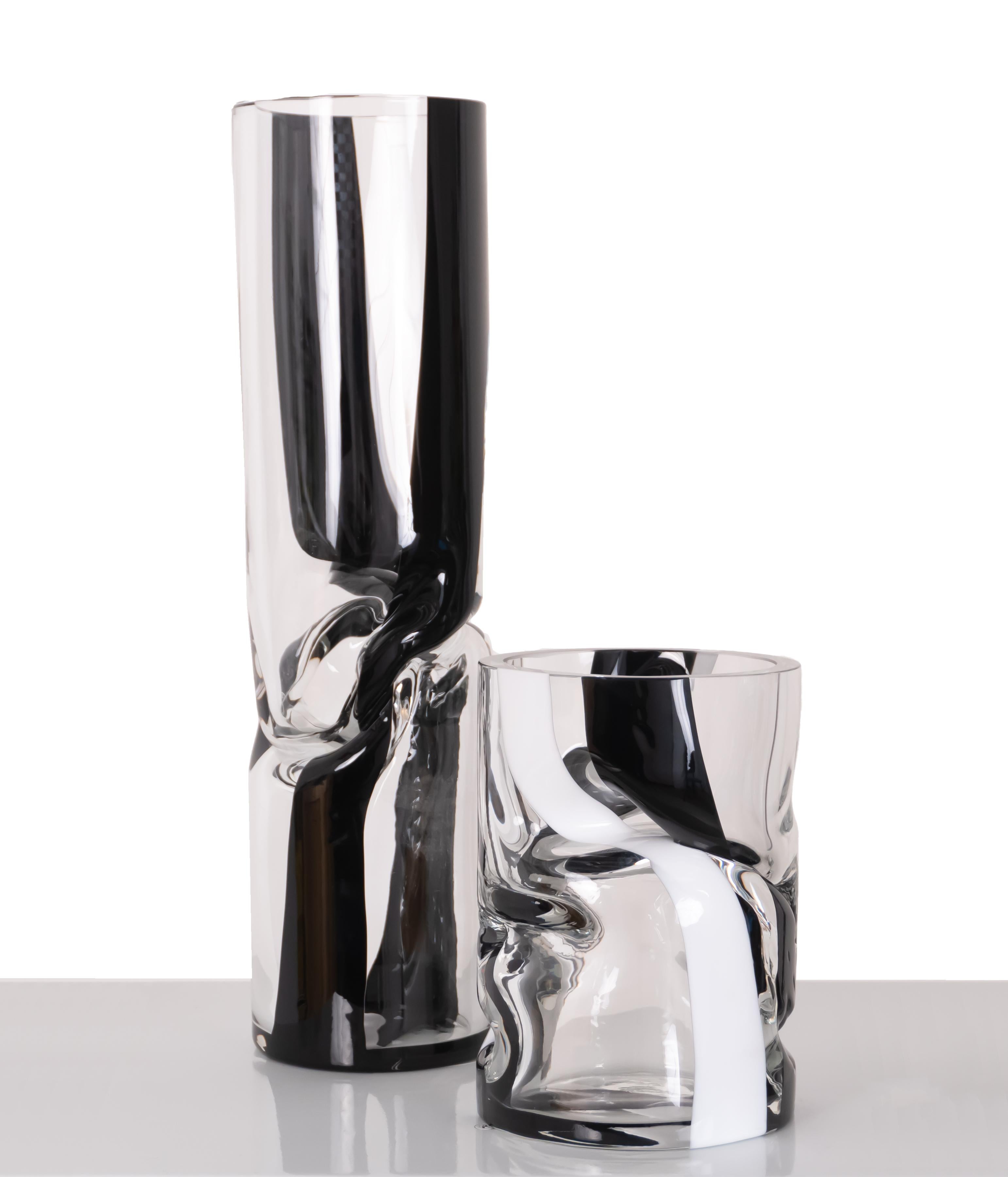 Combining black & white our small striped crushed vase uses contrast to maximum effect. This timeless mix and works beautifully with bold or soft tones.

During the glass blowing process, vases are twisted and shaped to create crushed forms within