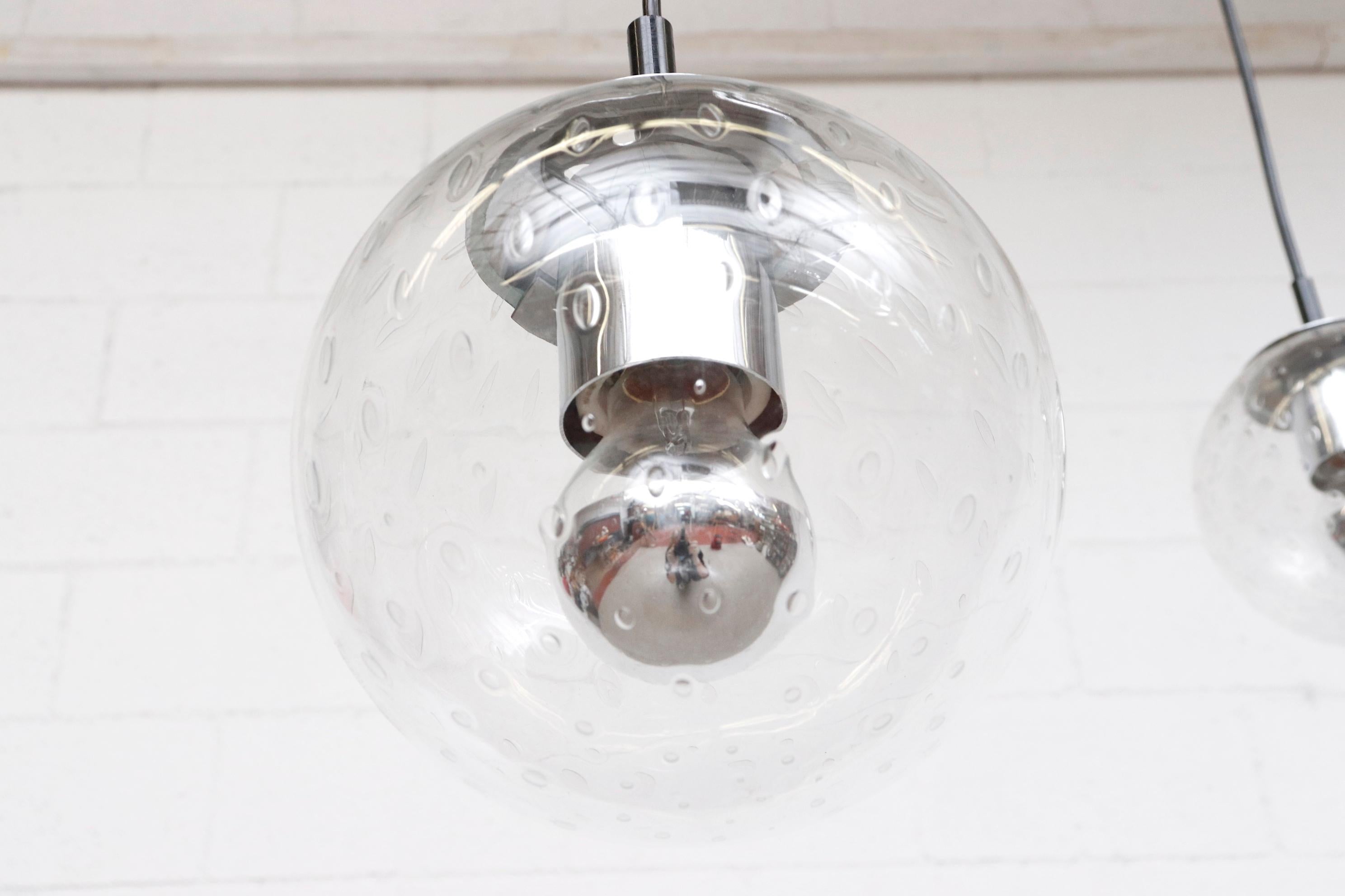 Small Hand Blown Glass Globe Pendants by RAAK with Chrome Hardware In Good Condition For Sale In Los Angeles, CA