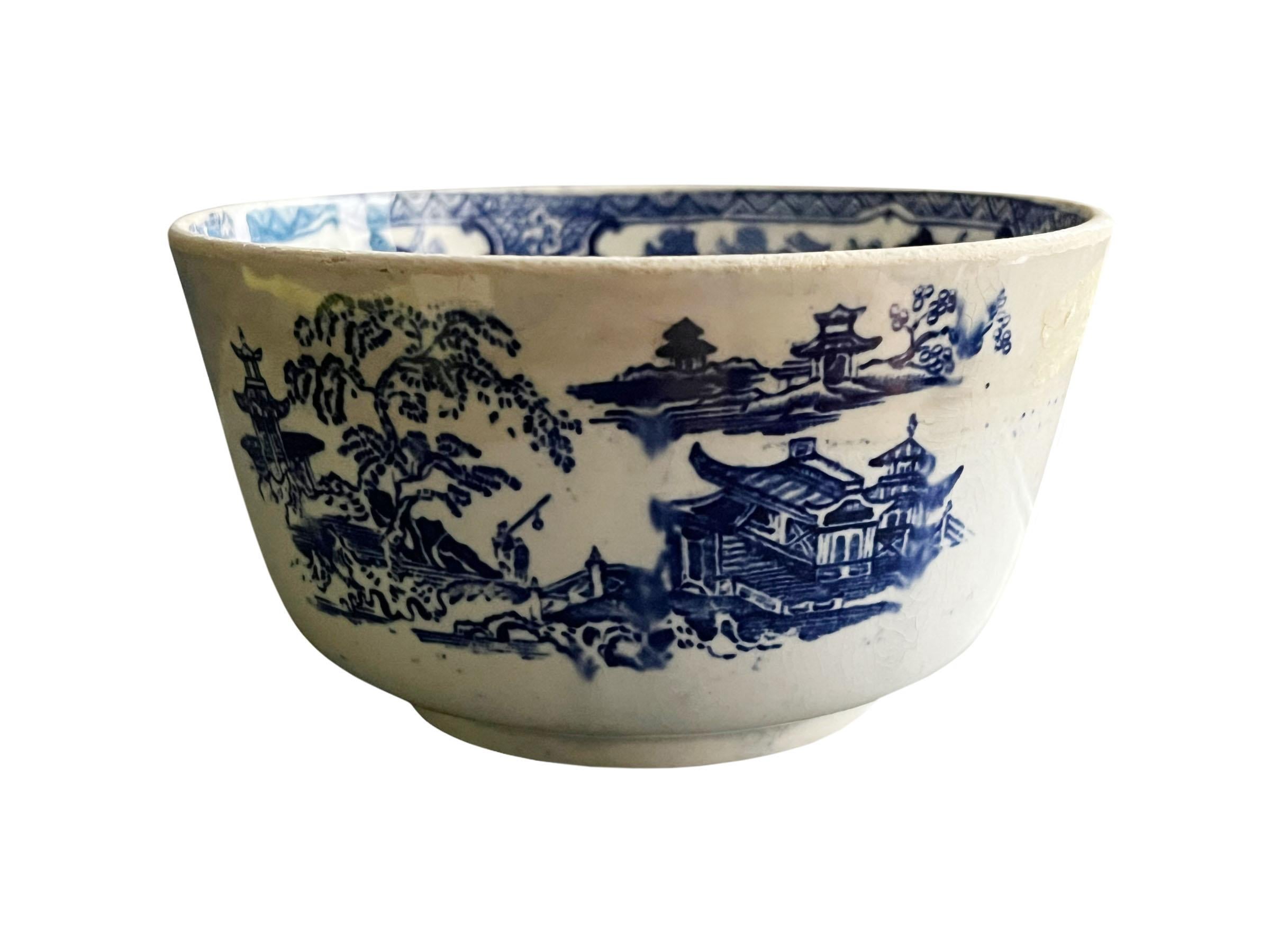 A small deep antique Adams & Company ironstone bowl with a Japanese scene painted in blurred tones of cobalt blue. The interior has the design around the top. Lots of signs of ware make this an even more precious piece.