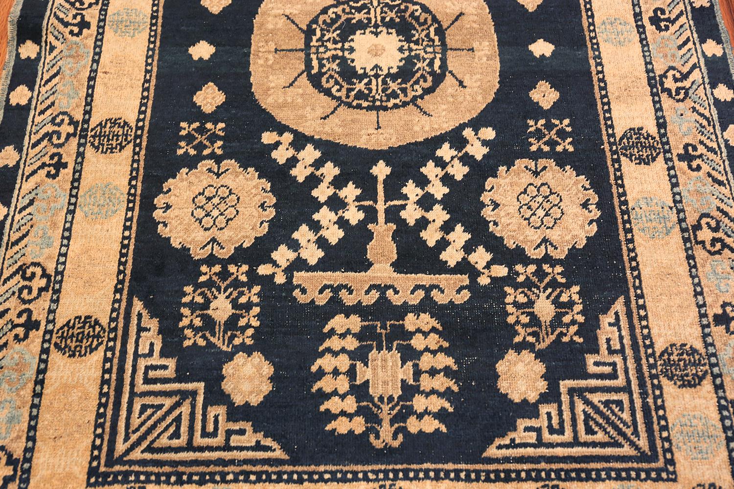 Beautiful small blue background antique Khotan rug, origin: East Turkestan, circa 1920. Size: 3 ft 4 in x 5 ft 6 in (1.02 m x 1.68 m). Khotan is a city in East Turkestan that was once at the crossroads of trade. People of many cultures passed