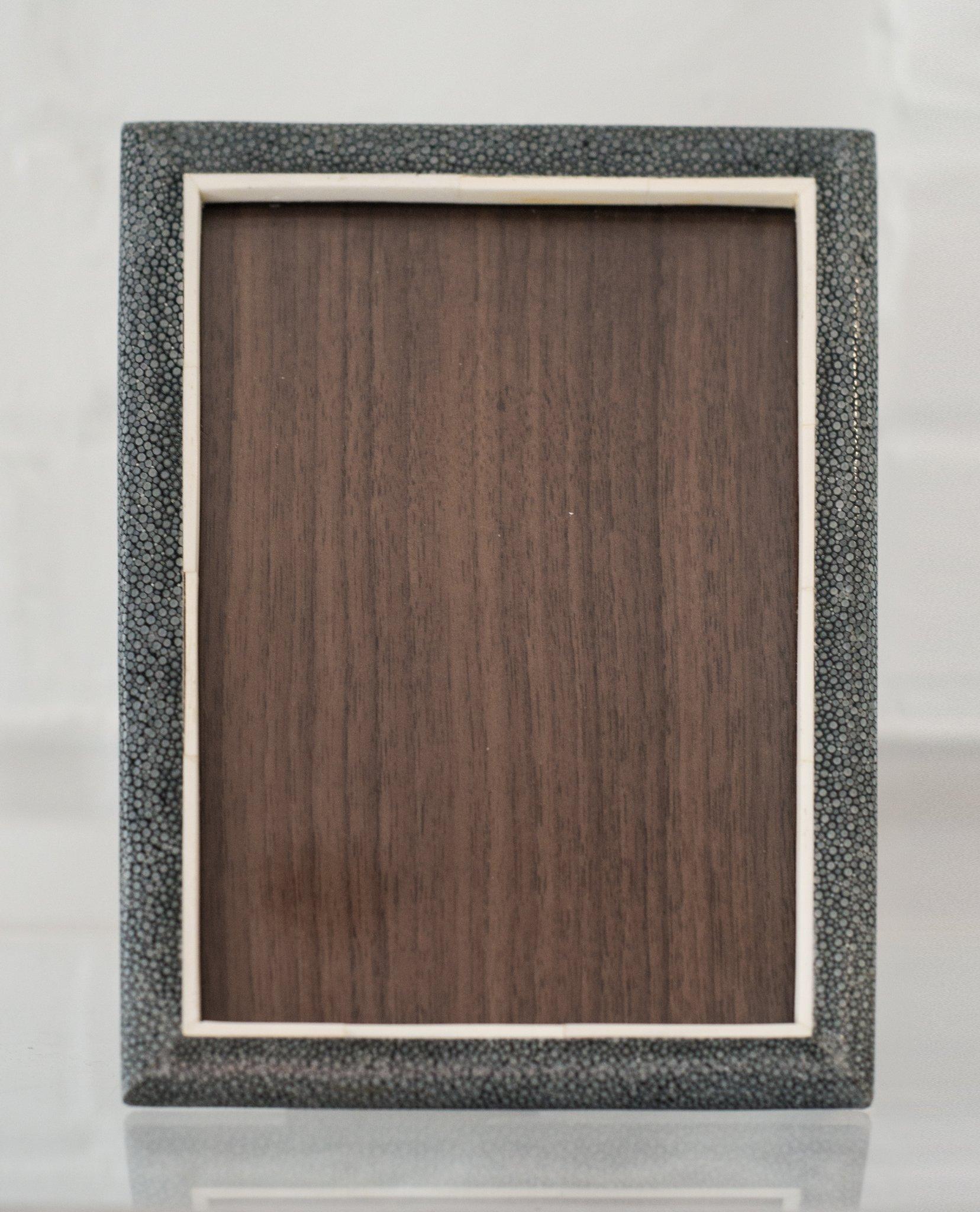 A small picture frame in blue/black Shagreen, bone and walnut. Accommodates one 5 x 7
