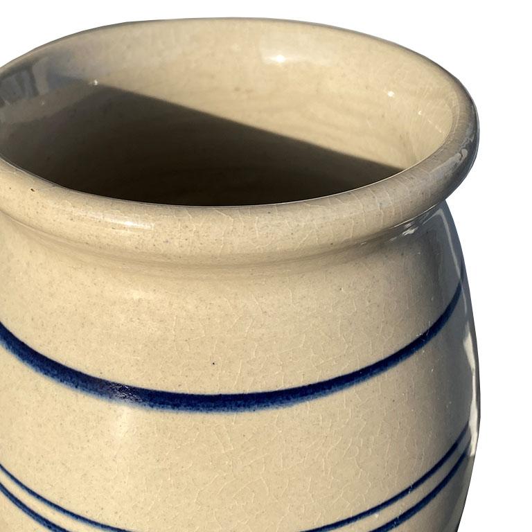Crocks are an icon in the south. This mini crock is a perfect way to add a touch of classic style to any room. Created from ceramic, though it feels much more like ironstone, this round crock is glazed in a light cream, with blue concentric circles
