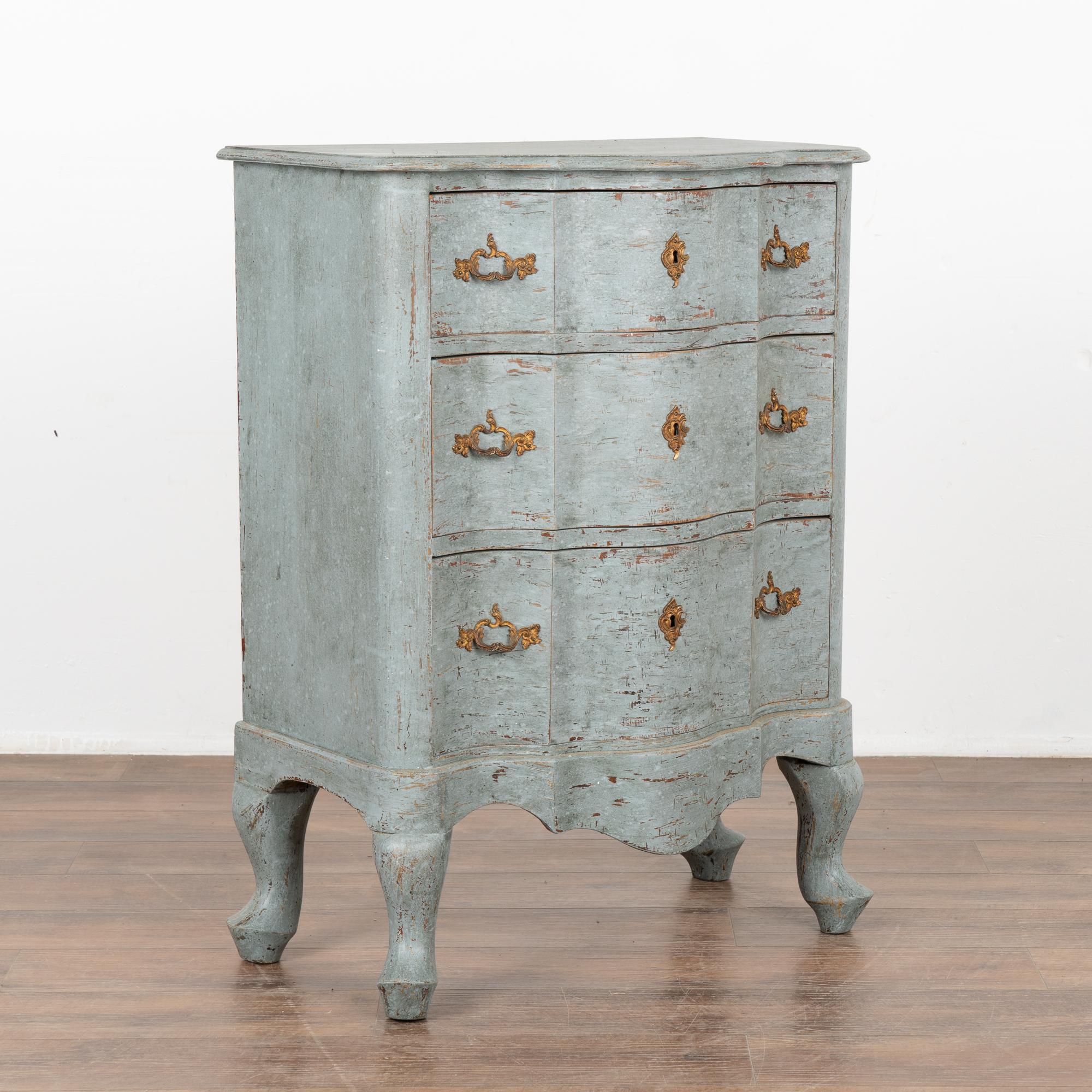 A small pine rococo chest of three drawers with brass key escutcheons. The scalloped edge is carried down through the 3 drawer fronts and bottom apron resulting in an elegant chest all resting on four cabriole legs.
The newer, professionally applied