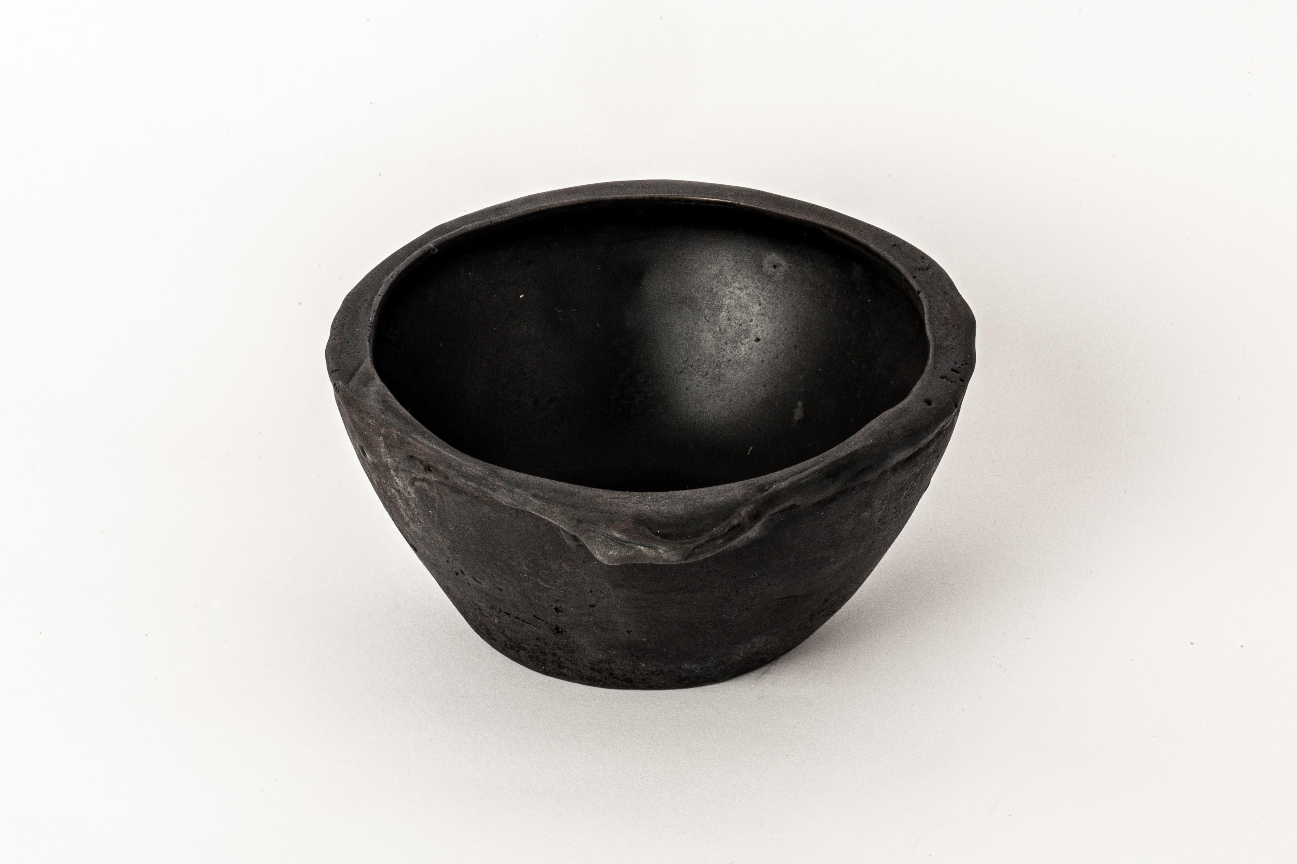 Small bowl in bronze.  It is a harmonious fusion of textures and tones that gleams with radiant elegance. Its exterior, adorned with a subtle, tactile roughness, imparts a unique character and charm to piece. Perfect for adding a touch of artistry