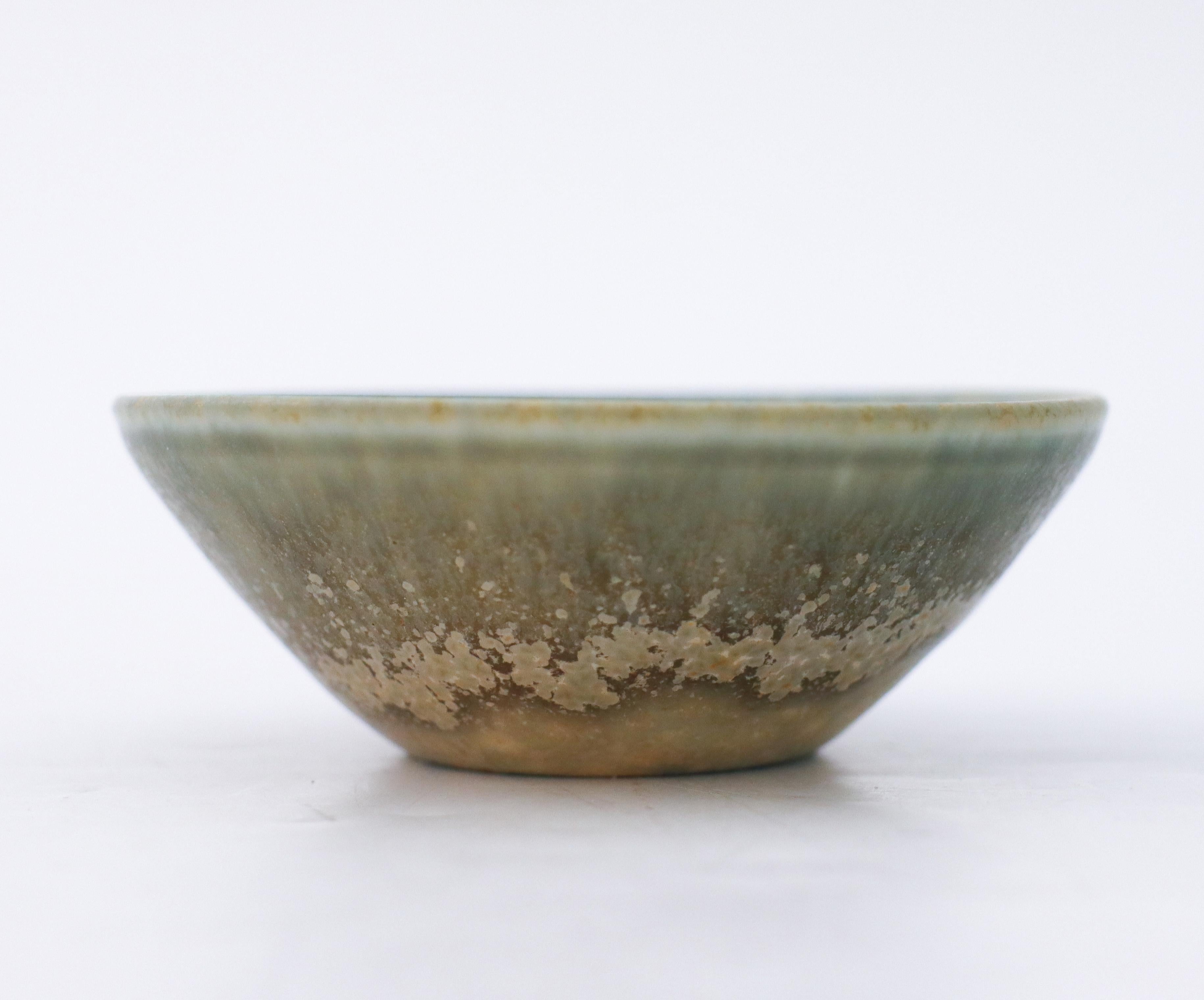 A round, small bowl with a lovely glaze designed by Carl-Harry Stålhane at Rörstrand. It´s 8.5 cm (3.4