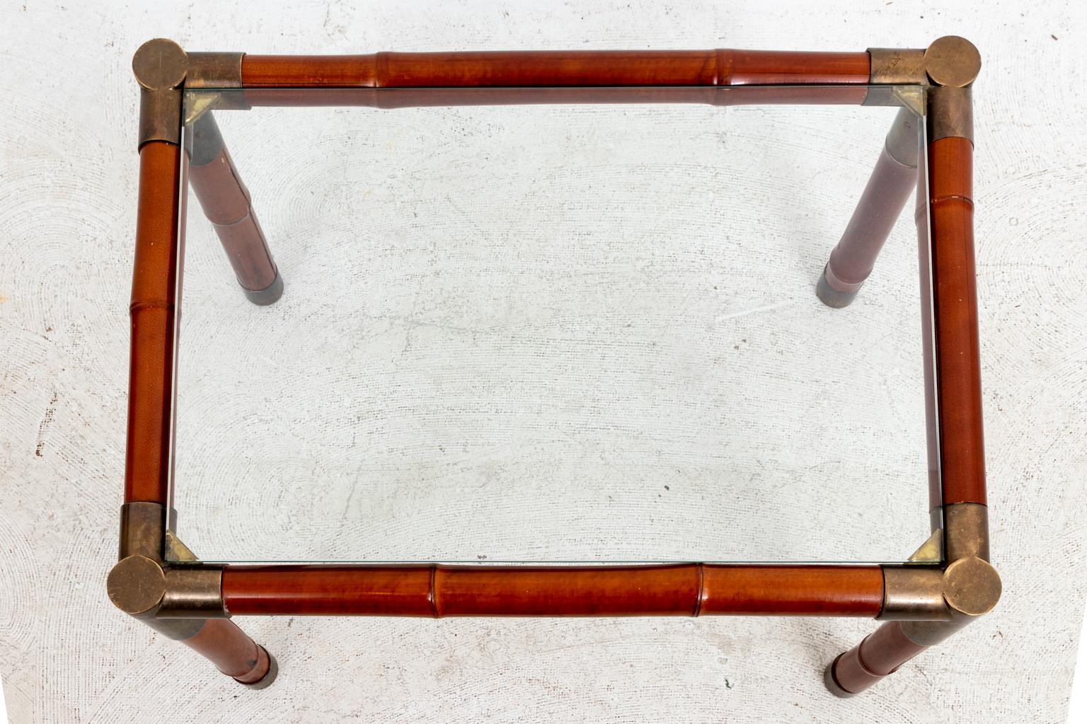 Brass banded side table with glass top by Willy Rizzo with faux-bamboo finished frame. Please note of wear consistent with age including chips and minor finish loss to the frame along with minor patina to the brass bands.