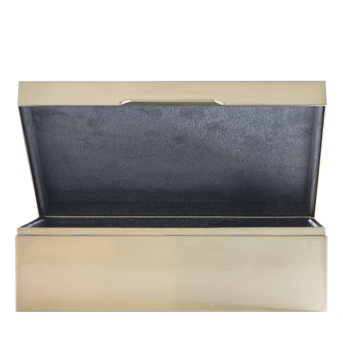 Lined in velvet and topped with a beetle, this box has everything required to keep precious objects safe. An eye-catching accent for any space, the brass box is designed and crafted in Florence by Badari, true luxury experts. Place it on a side