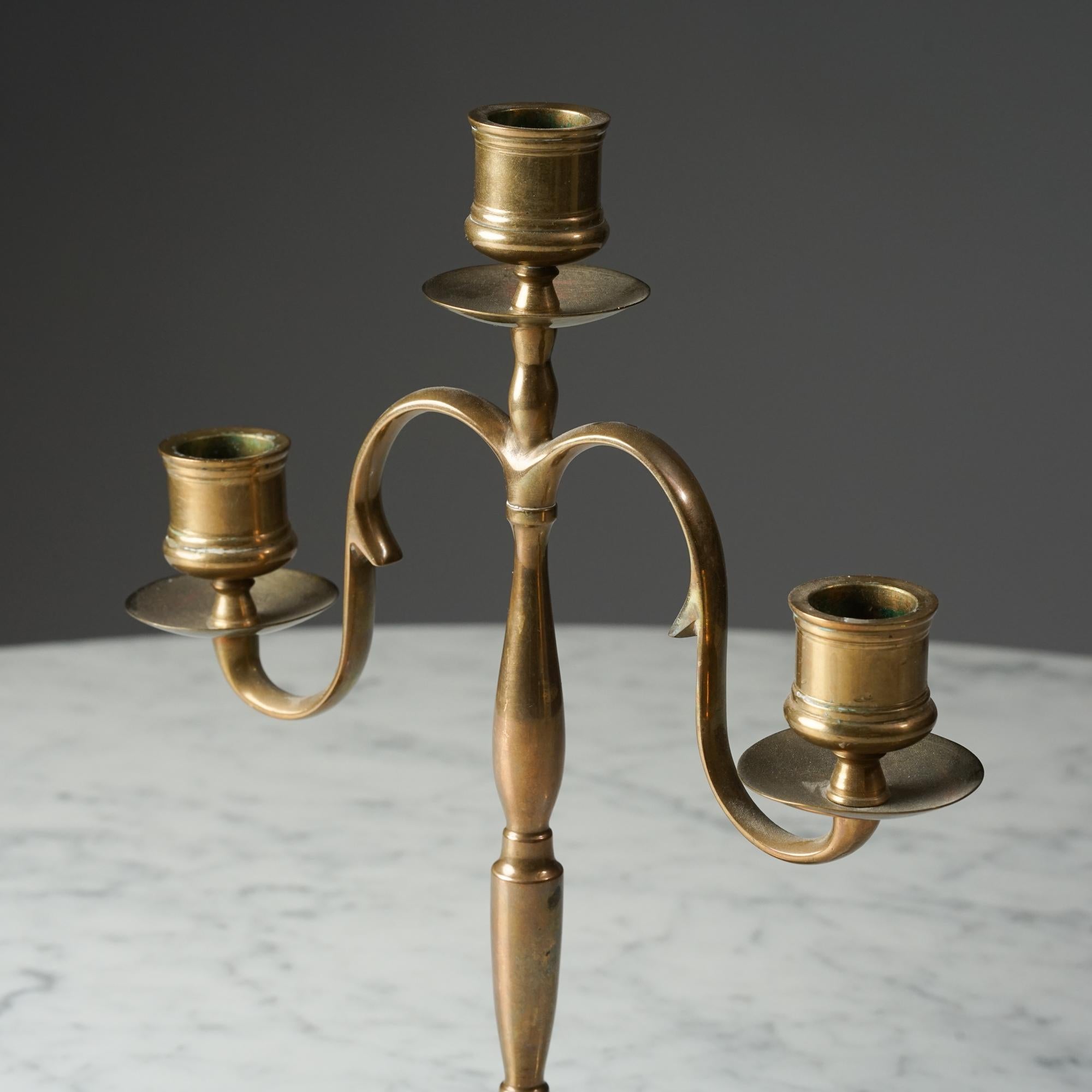 A Classic Paavo Tynell Bronze Candelabra

This small candelabra is a classic design by Finnish architect and designer Paavo Tynell. It was made in Finland by Taito Oy in the 1920s or 1930s.

The candelabra is made of brass and features a simple,