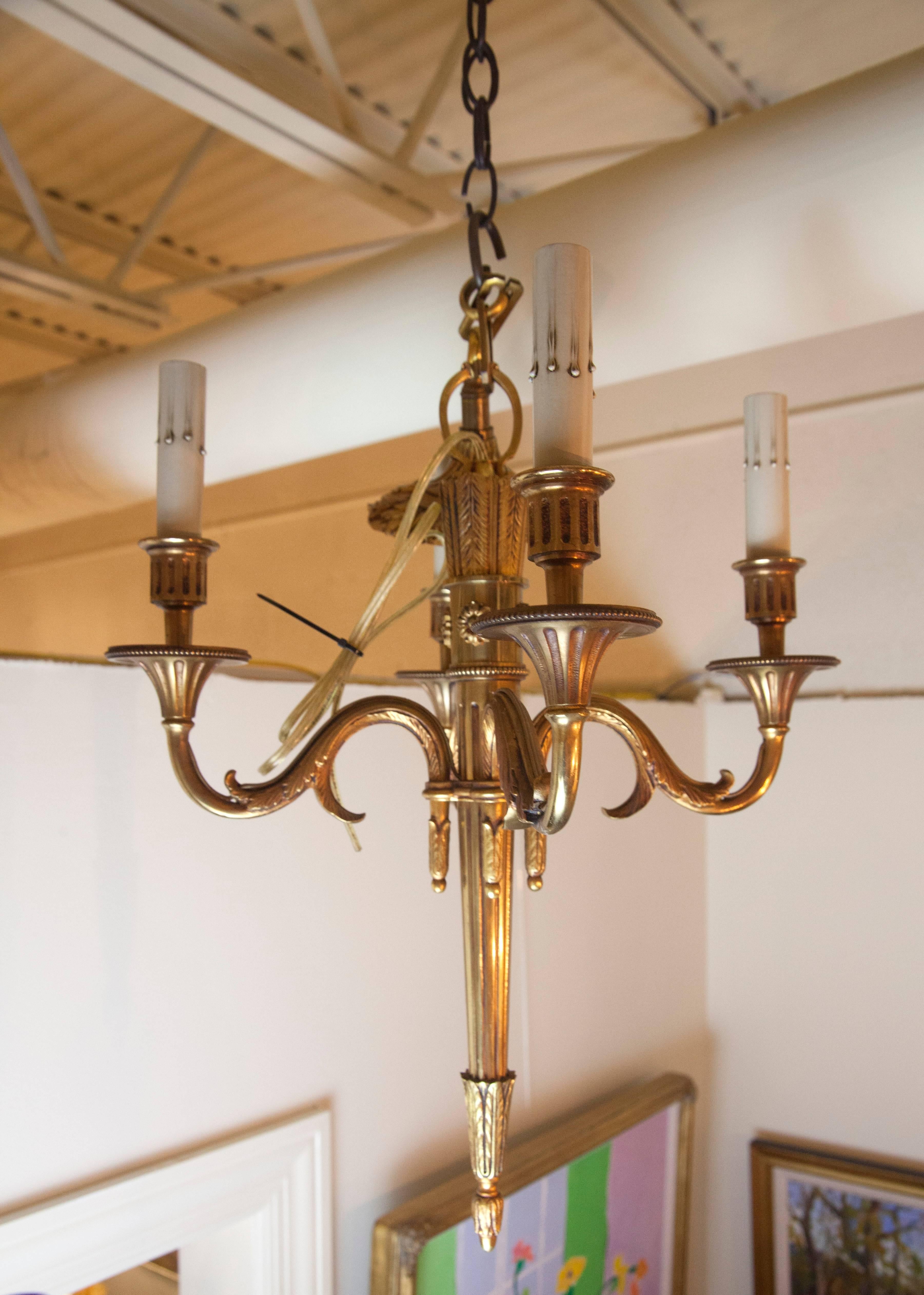 This small bronze Empire chandelier has four arms and has been newly rewired for American use.