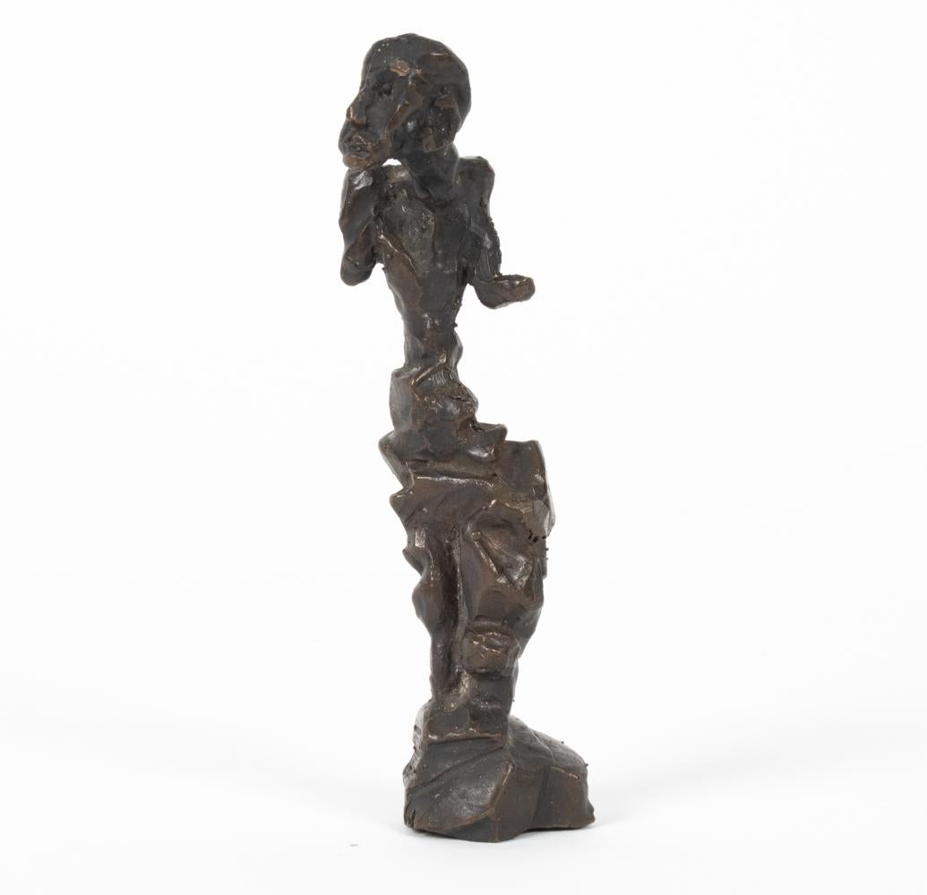 This small charming abstract bronze figure stands on its own with a curious look on its face. This piece would make a great desk accessory or a petite tabletop sculpture. Unsigned with a beautiful dark bronze patina ready to delight.
