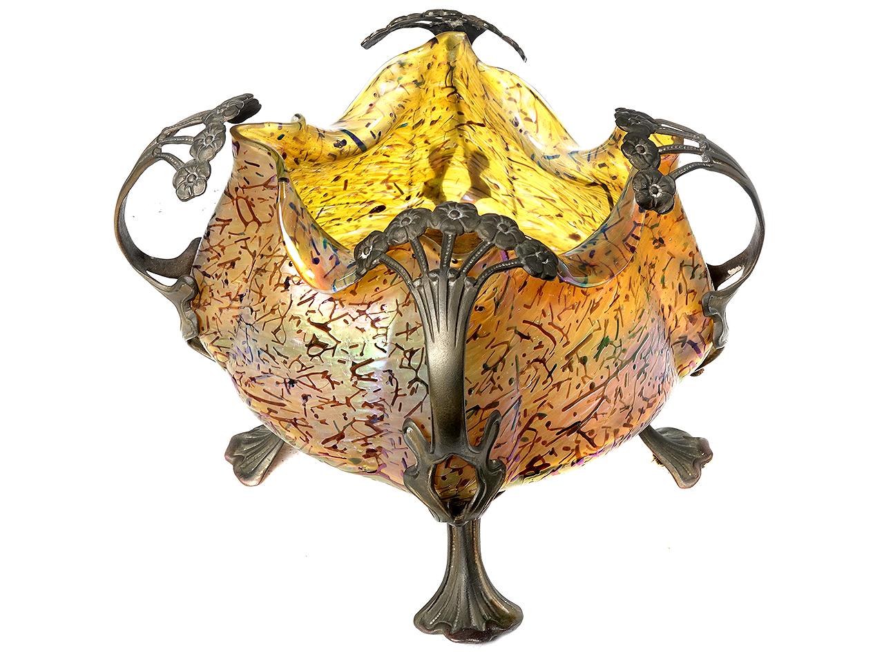 This beautiful gem is unsigned but the bronze footed metal work and patterned glass all say Loetz. The glass is amazing with its iridescent finish, shape and texture. 
 