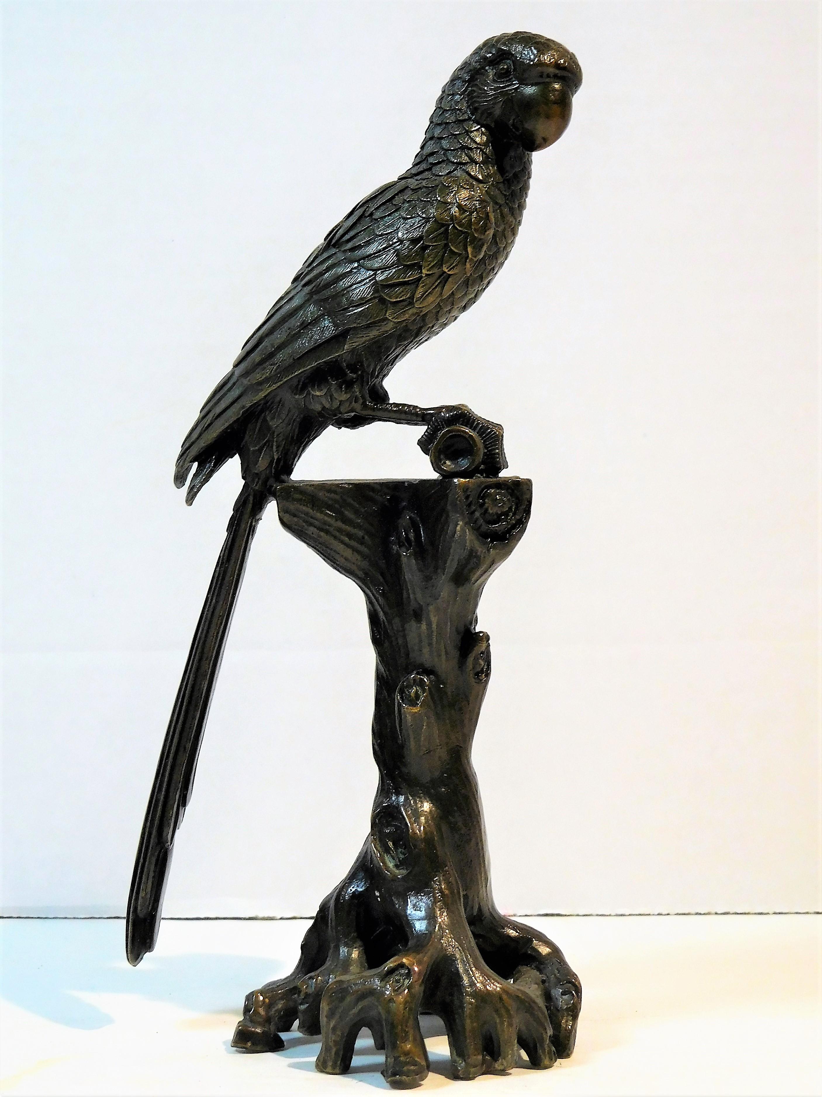 This tabletop figure of a finely cast bronze cockatoo parrot is rich in detail, as seen in the photos. The tree-trunk pedestal with its mass of roots and its realistic bark, adds a sense of the parrot's natural surroundings. The claws of the parrot
