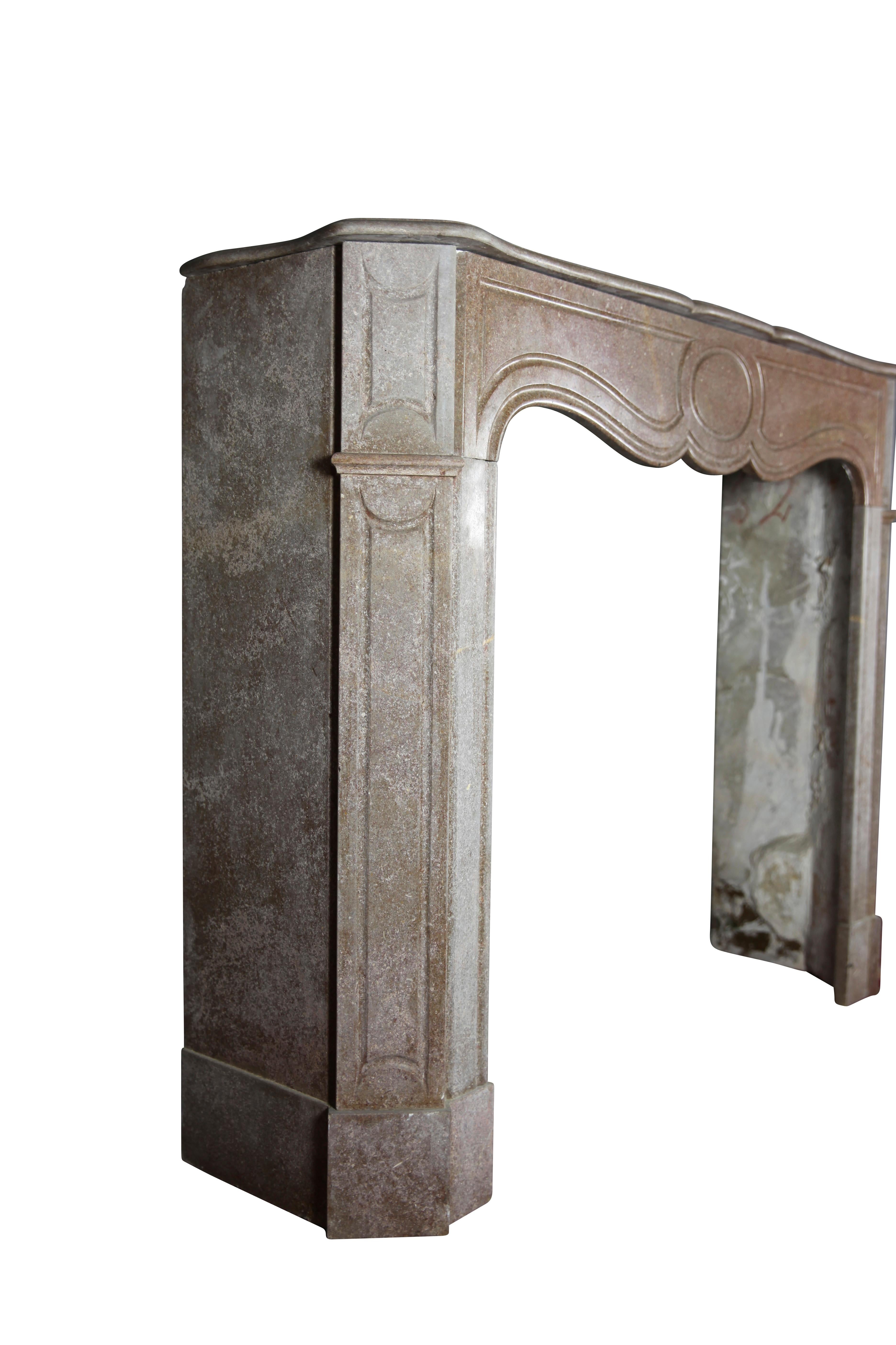 Antique fireplace surround in Buxy. The Buxy marble stone was majorly used in Monaco. It was made in the Pompadour period, 19th century. 
Measures:
125 cm exterior width 49.21 inch
101 cm exterior height 39.76 inch
90 cm interior width 35.43