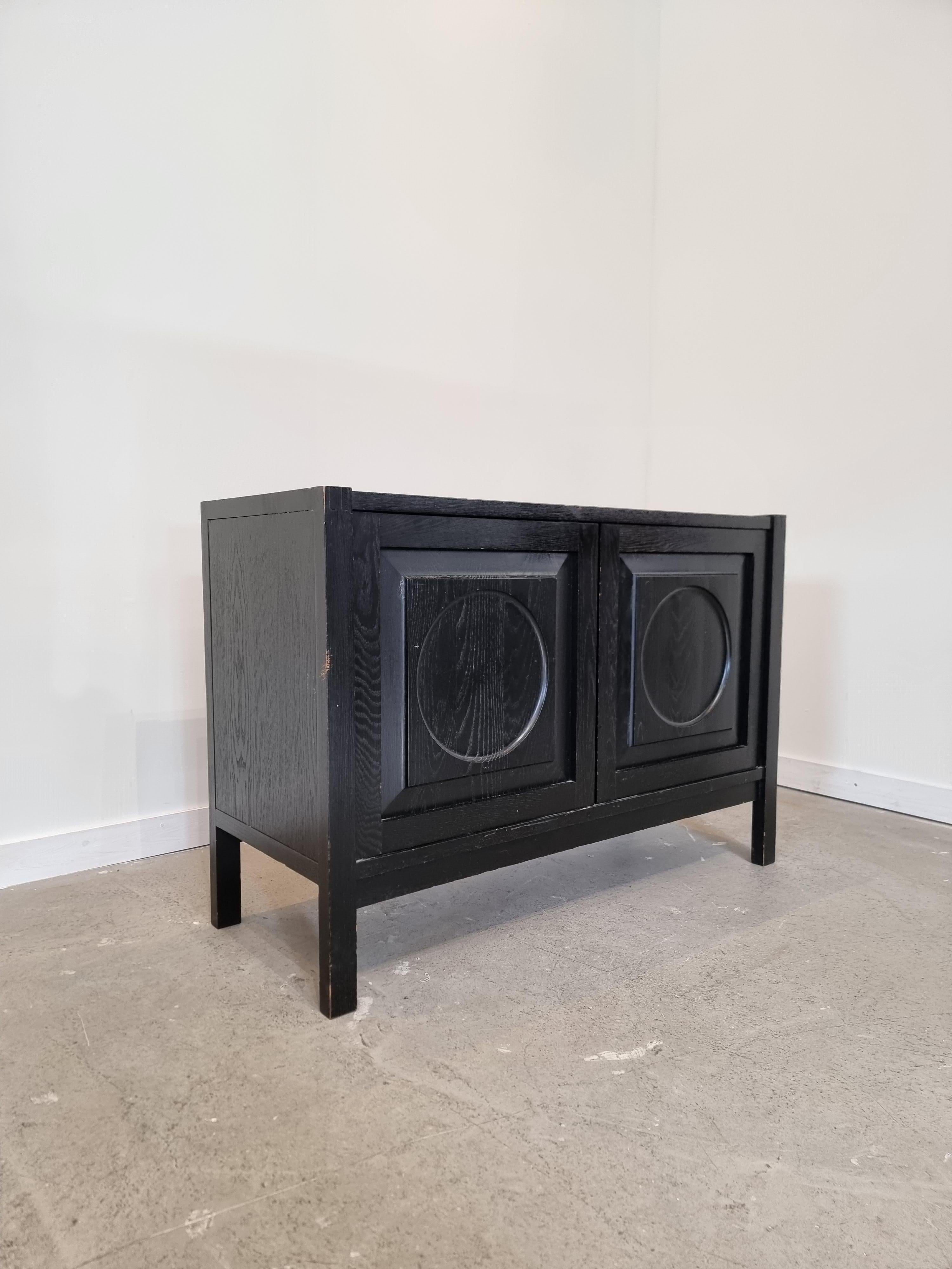 Black brutalist sideboard in very nice condition with amazing and original patina on the wood.

Made in Belgium 1970s.

The sideboard/ cabinet has two doors made of massive Black stained oak, each with a three-dimensional pattern. Visibale