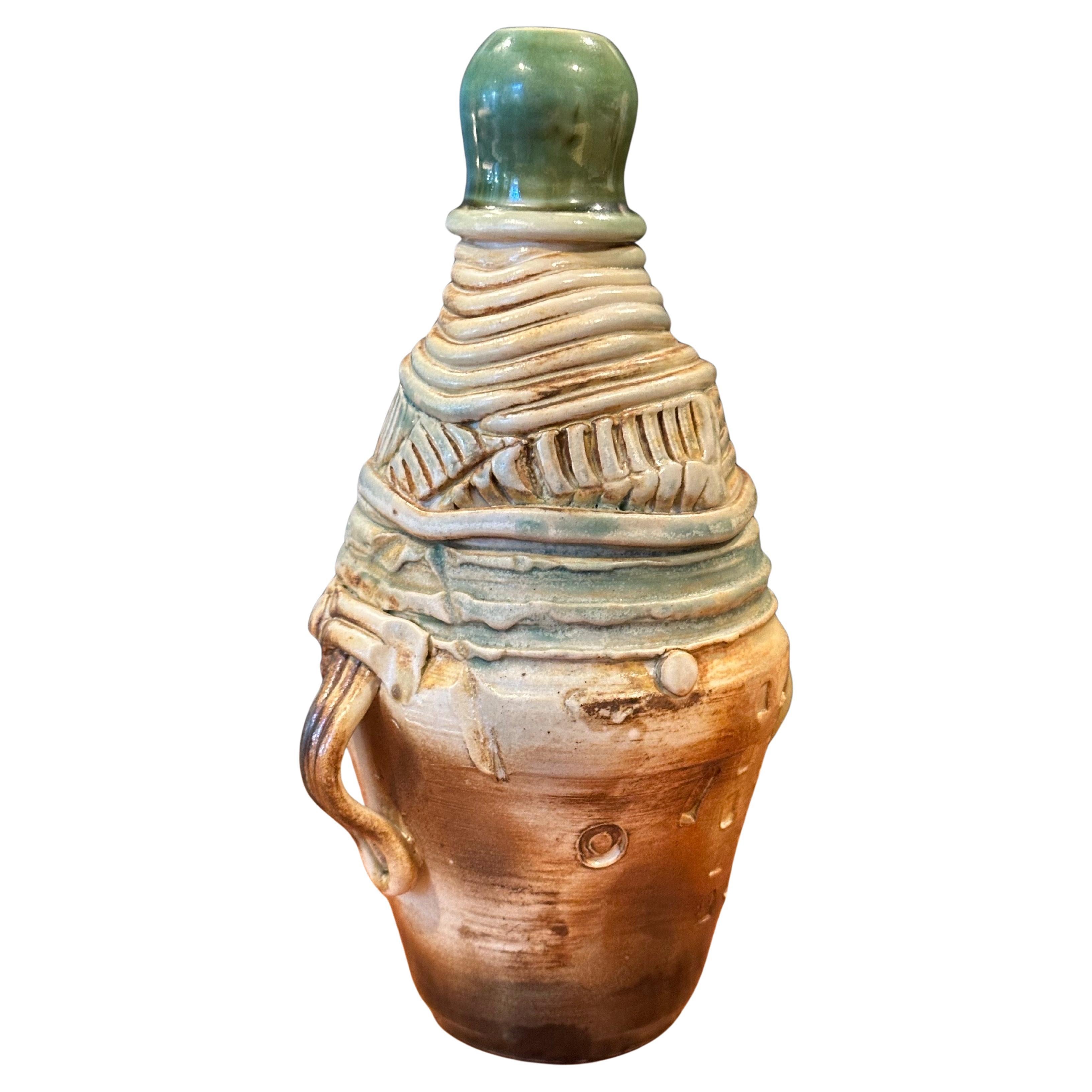 An interesting figural brutalist studio pottery stoneware vase, circa 1970s. It is has an abstract Picasso influenced look to it.  Very cool and different piece that is signed on the underside. The vase is in very good condition with no chips or