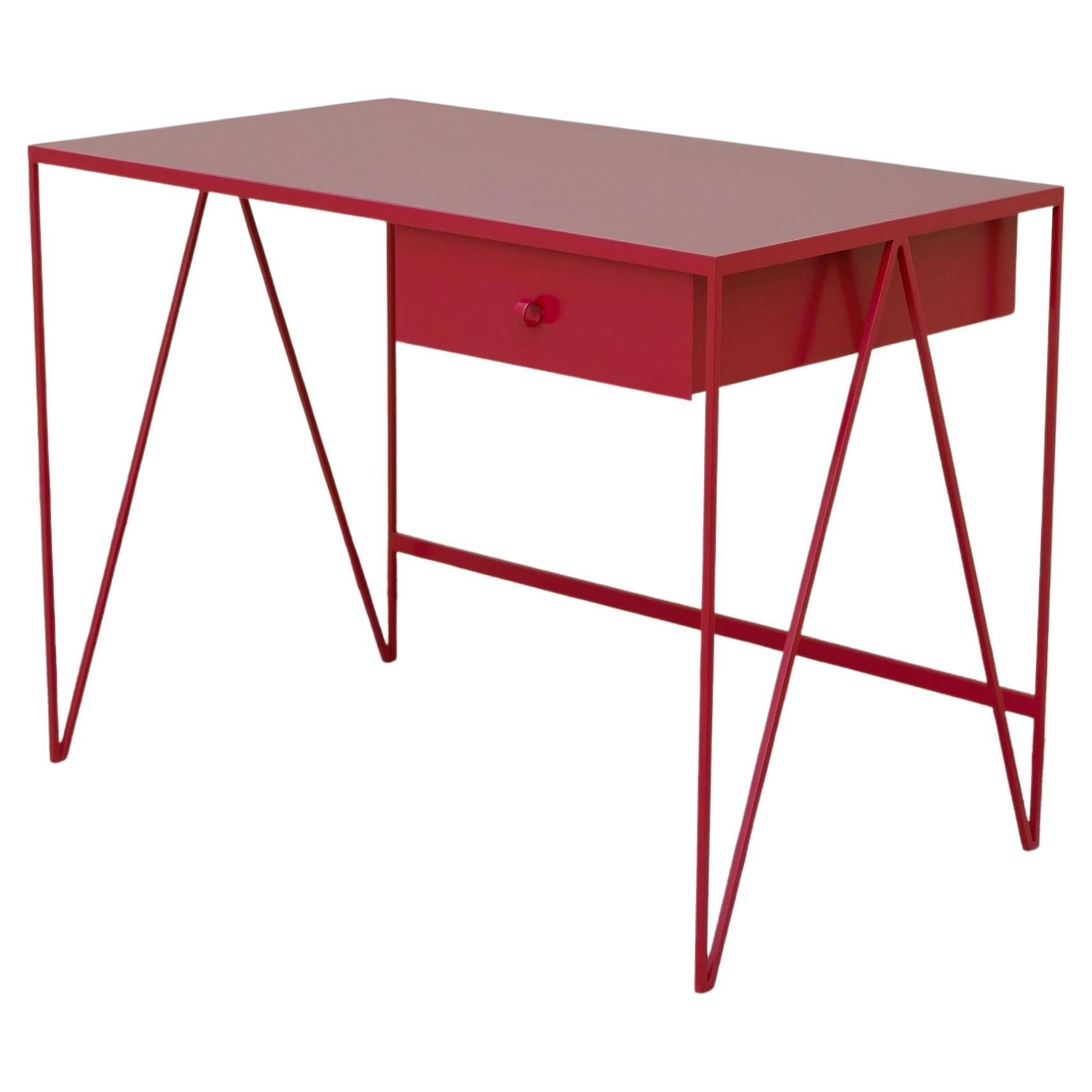 This small study desk is made with a beetroot powder-coated steel frame and a burgundy coloured natural linoleum tabletop. The linoleum for our desks is selected for the ecological properties of the linseed of which it is made. It also has a smooth