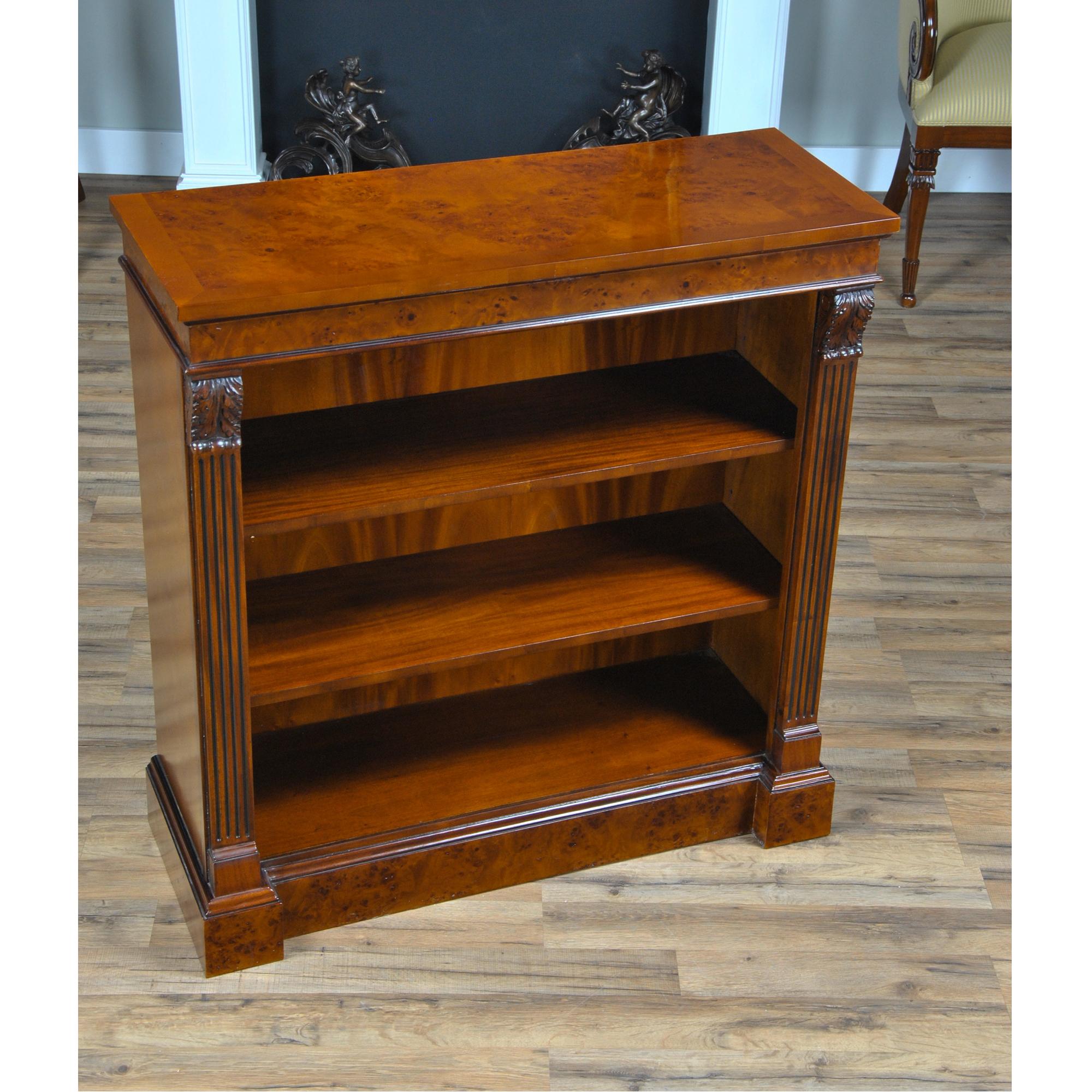 The Niagara Furniture Small Burled Penshurst Bookcase with two shelves. The burled cornice is beautiful and adds a sense of depth to the upper area of the case while hand carved acanthus style, solid mahogany brackets and reeded columns lend a sense