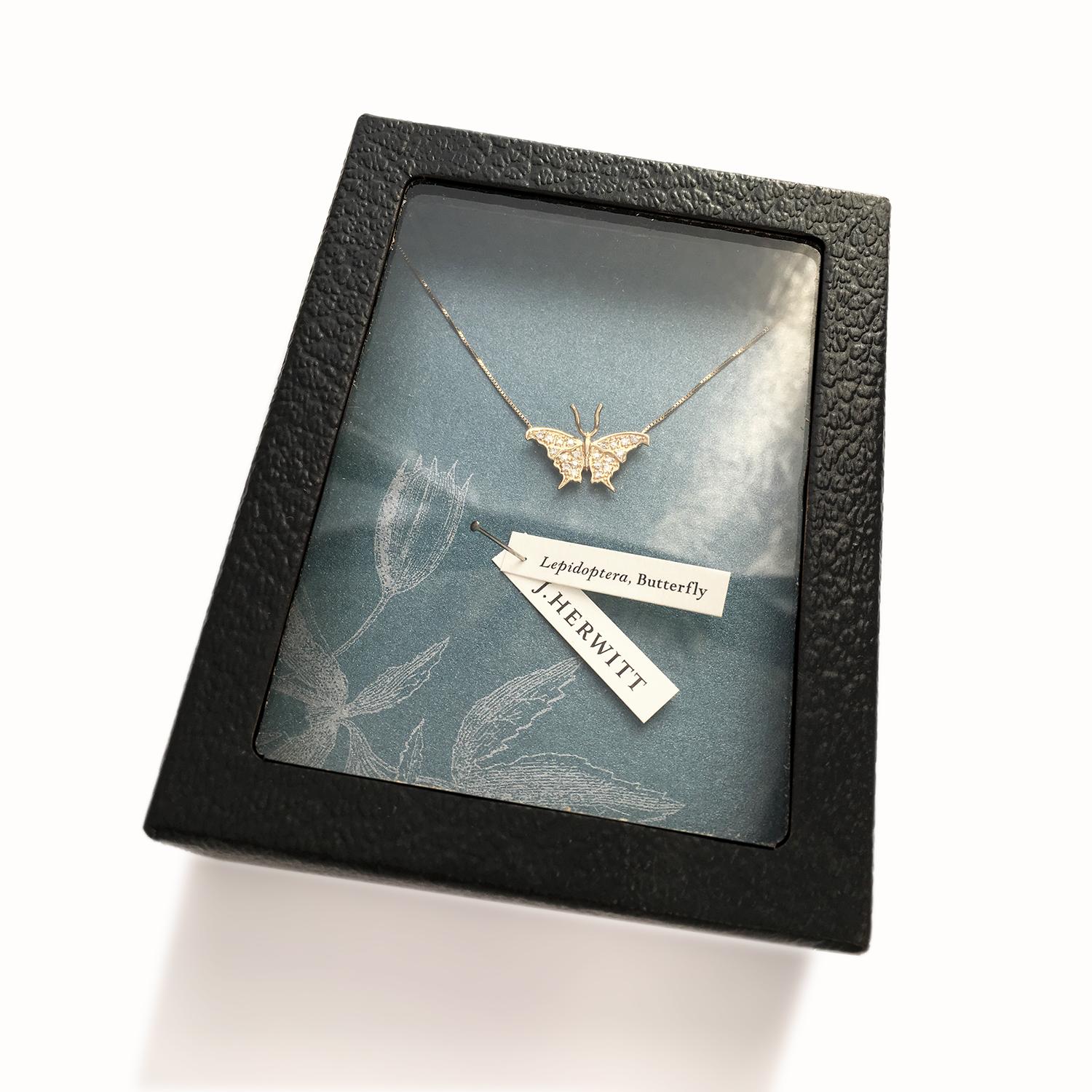 Experience the captivating beauty of our Small Butterfly Necklace, plated in lustrous yellow gold and adorned with stunning white sapphires. Embracing your neckline with grace, this enchanting piece is designed to make a statement. 

Crafted with