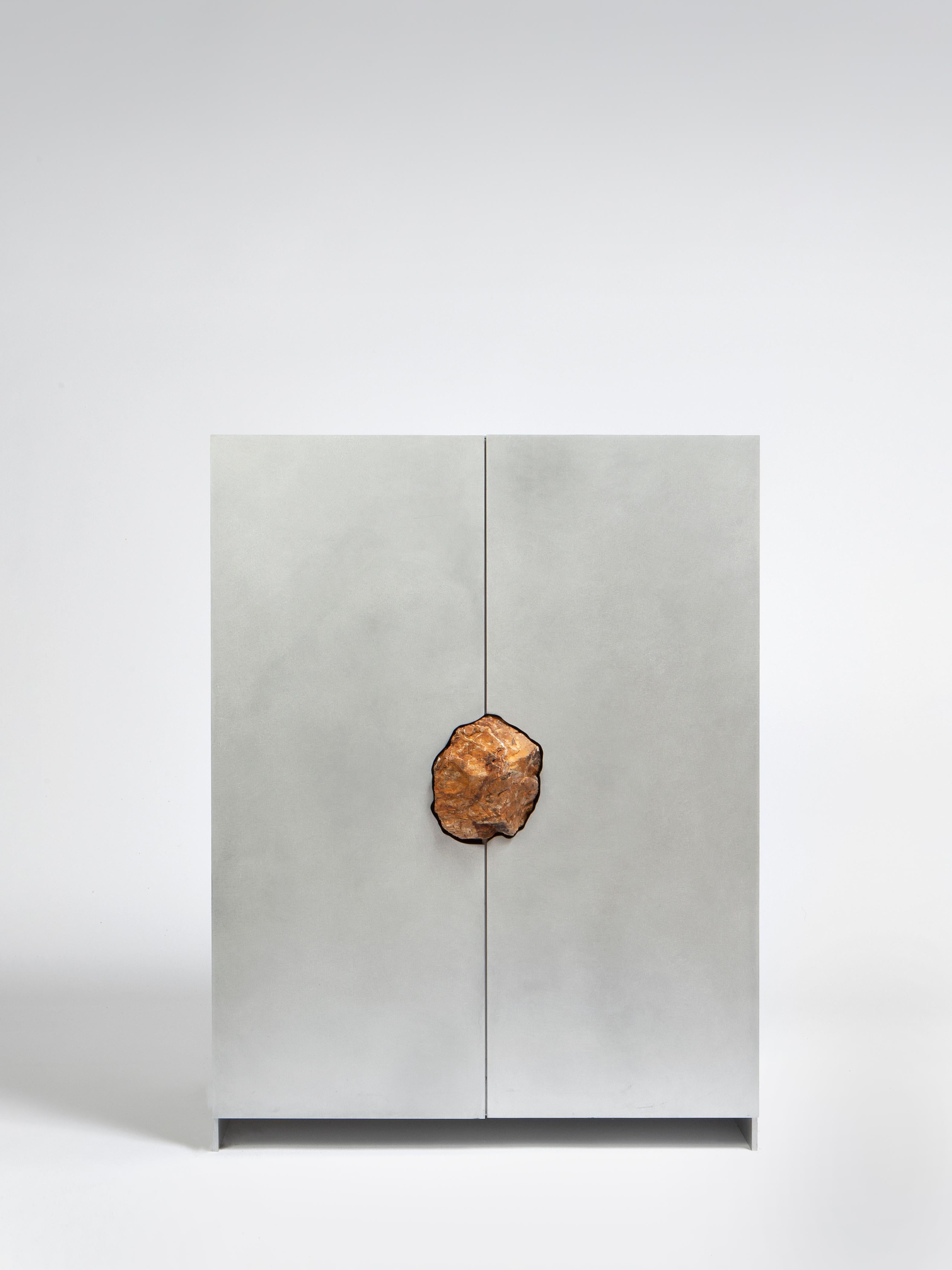Small cabinet with petrified oak by Pierre De Valck.
Dimensions: W 55 x D 34 x H 70 cm.
Materials: Waxed aluminium with petrified oak
Weight: 35 kg.
Each piece is unique.

Pierre De Valck (1991) born in Brussels, is a Ghent-based designer with