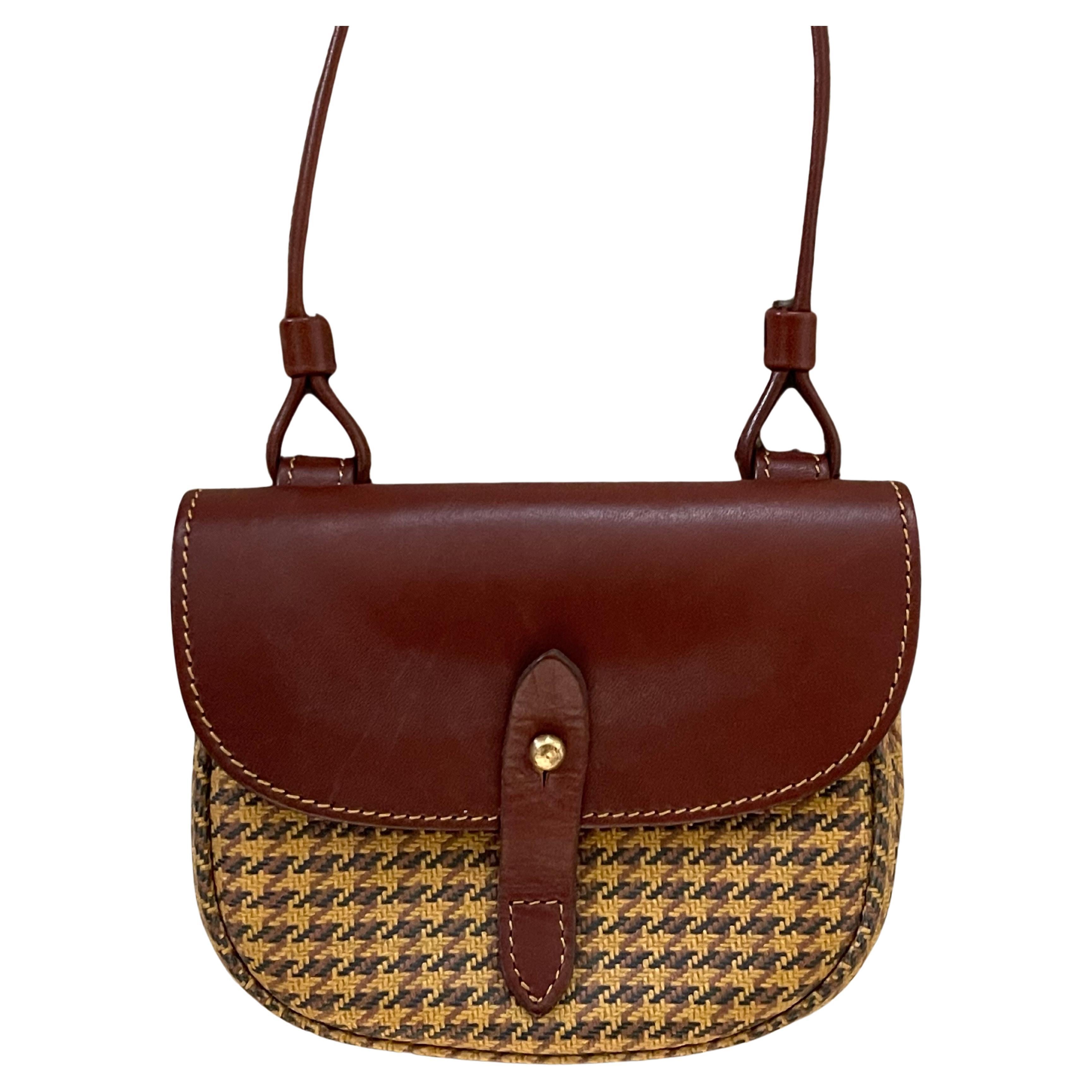 Small cartridge houndstooth shoulder bag by Marley Hodgson for Ghurka, circa 1990s.  The bag is in good vintage condition and measures 6