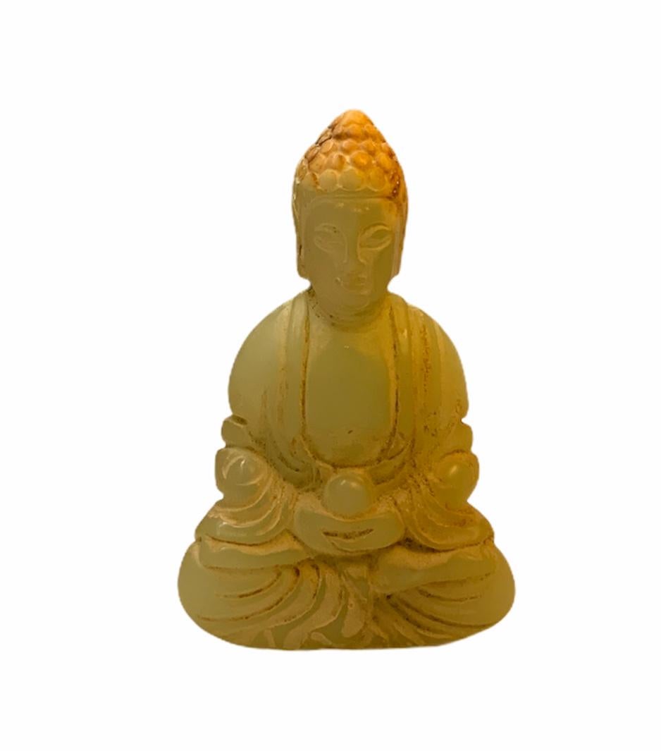 This is a carved jade sitting Buddha small sculpture.