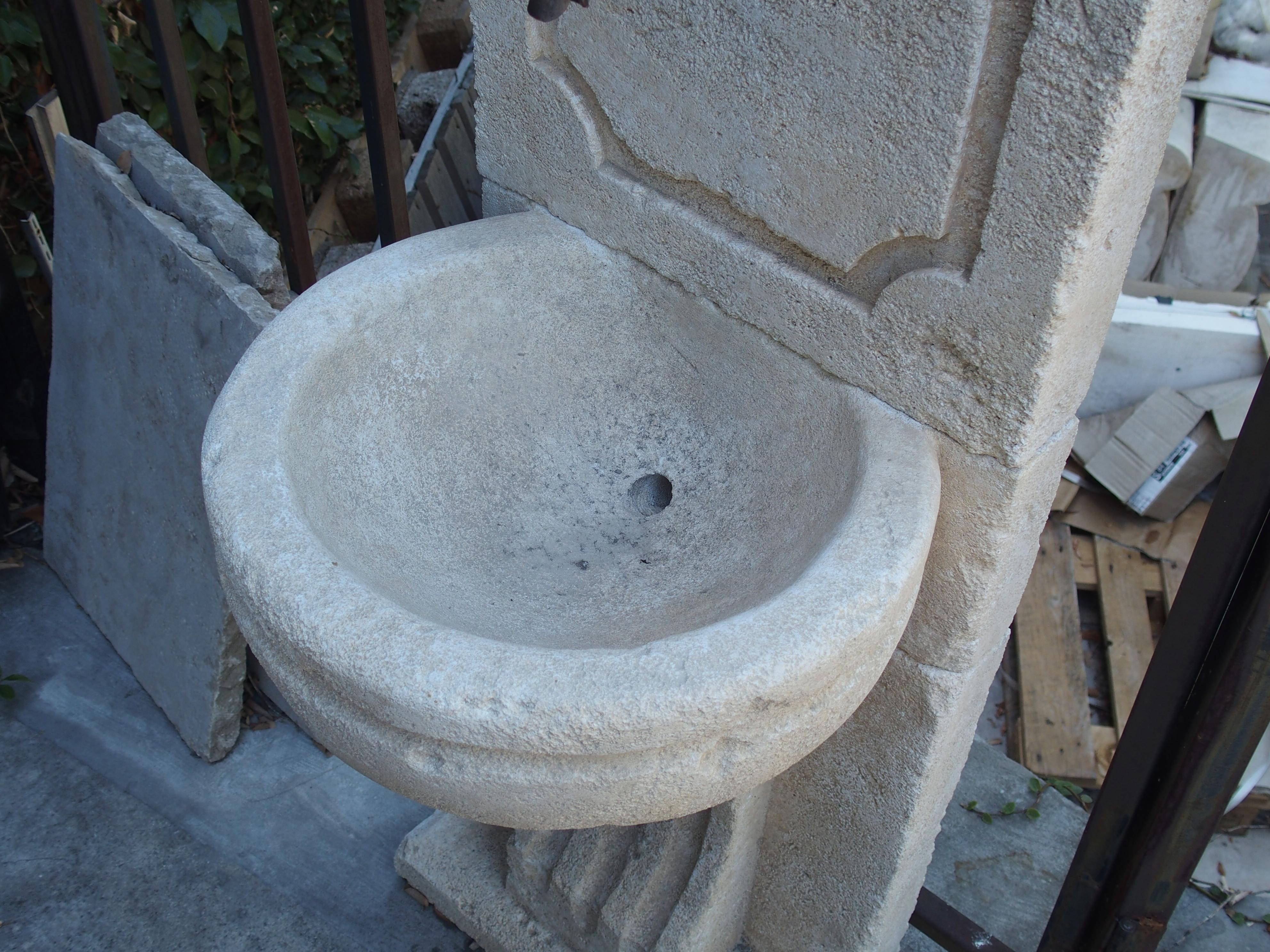 This charming wall fountain has been hand-carved from Estaillade limestone in the South of France. It is composed of 4-stone sections and comes with a small wrought iron spout. It's small size permit it to be placed in nearly any sized space, and it
