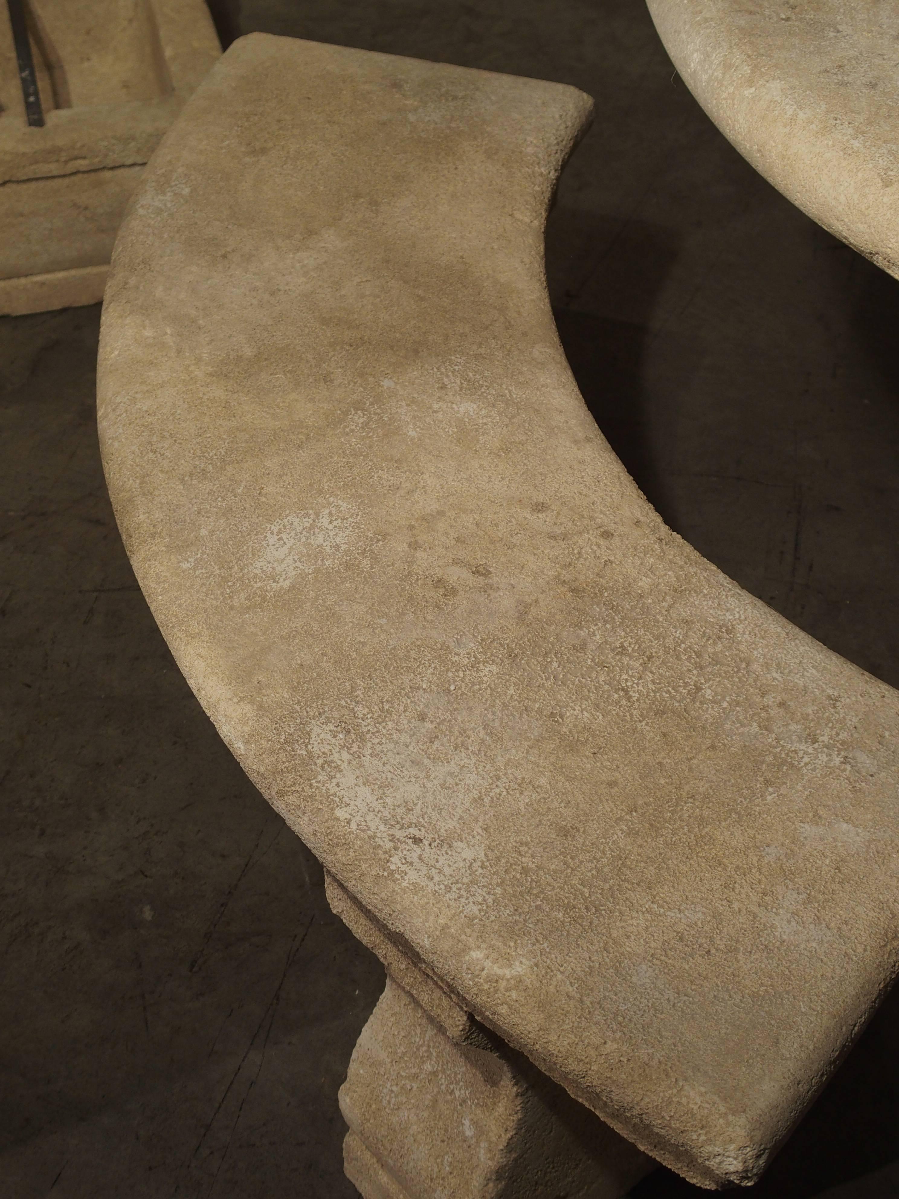 This hand carved limestone bench park bench is from Provence, France. The seat is one solid stepped in piece of stone, and it rests upon two shaped block legs and feet. Perfect for placing with a table or left on its own in a garden, this curved