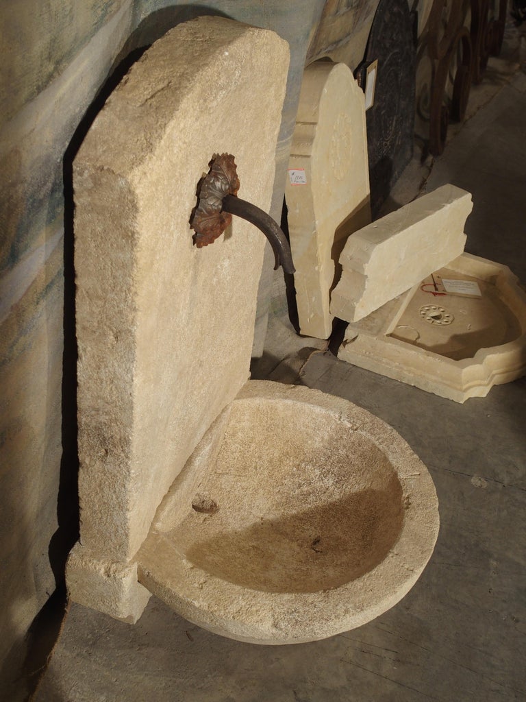 Small Carved Limestone Wall Fountain with Circular Basin For Sale at